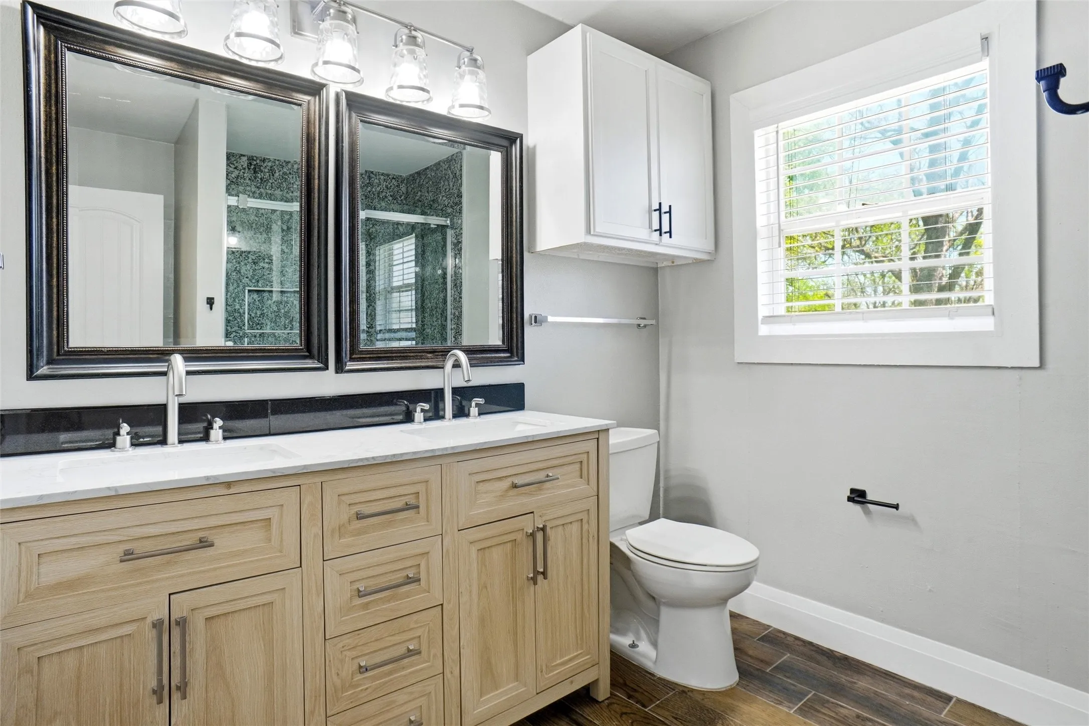 remodeled hall bath with duar sinks, medicine cabinet, new vanity, lights & mirrors