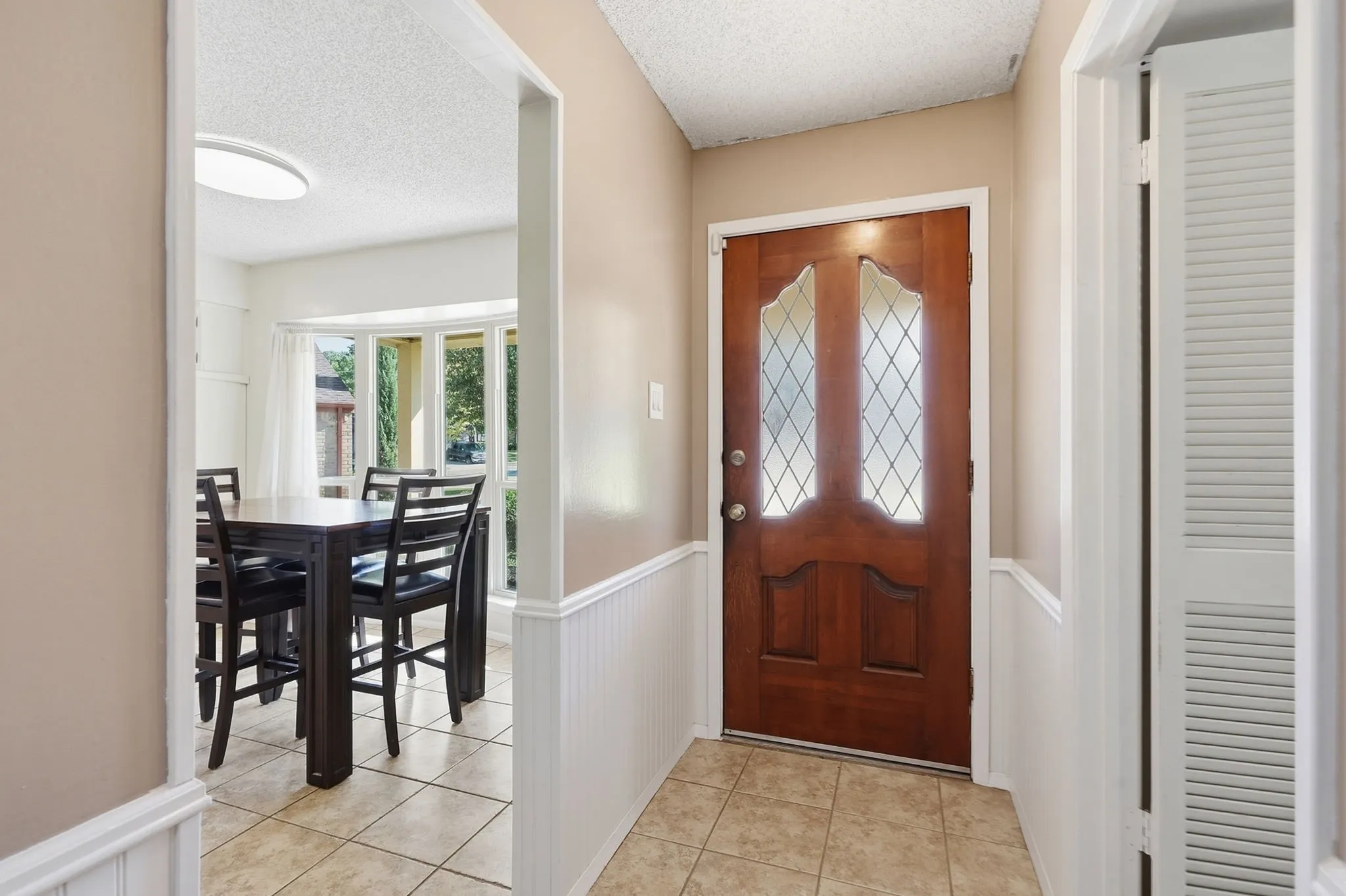 Solid wood entry door with decorative glass inserts