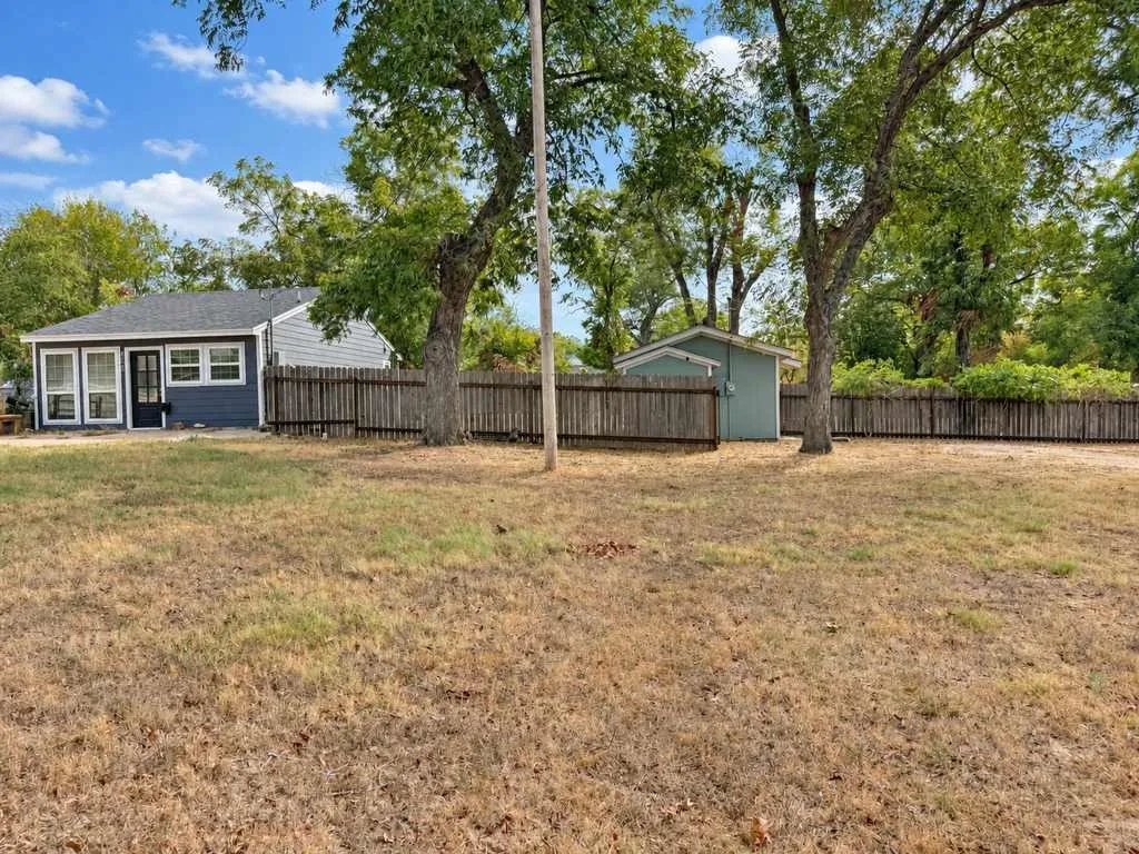 Mature trees and substantial open yard space create separation between the residences.