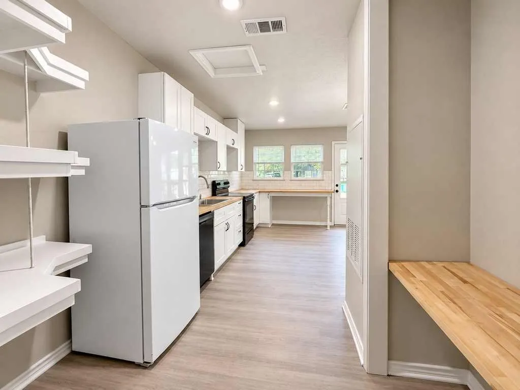 Built-in shelving, additional work surface and easy access into the kitchen.
