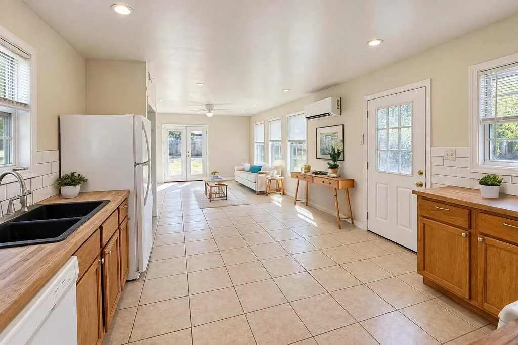 Virtually staged to illustrate the open-concept living space and flexible furniture arrangement.