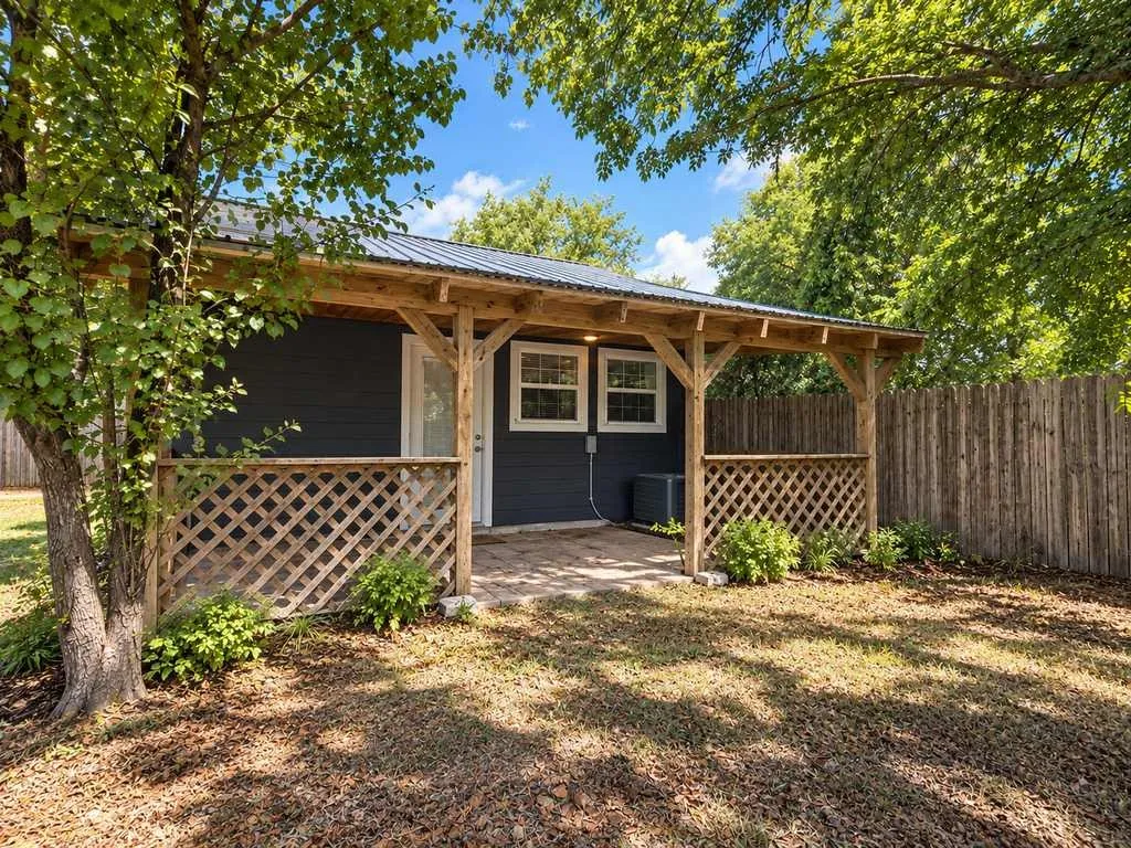 Covered patio adds a comfortable transition between the home and expansive backyard.