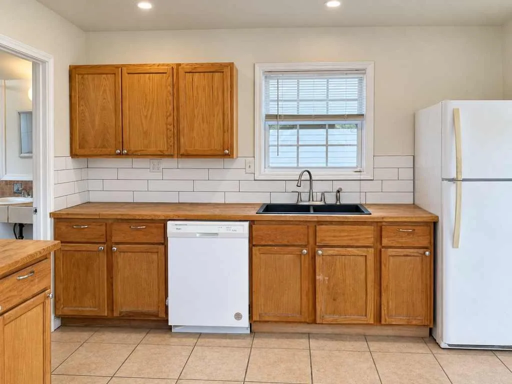 Window over the sink, dishwasher, refrigerator and ample cabinetry provide everyday functionality.