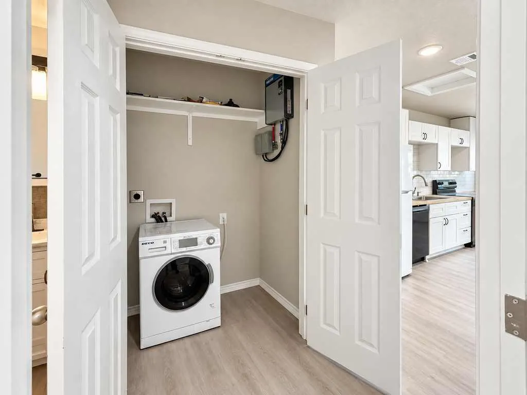 Dedicated laundry closet with hookups and additional storage space. Laundry appliance shown does not convey.