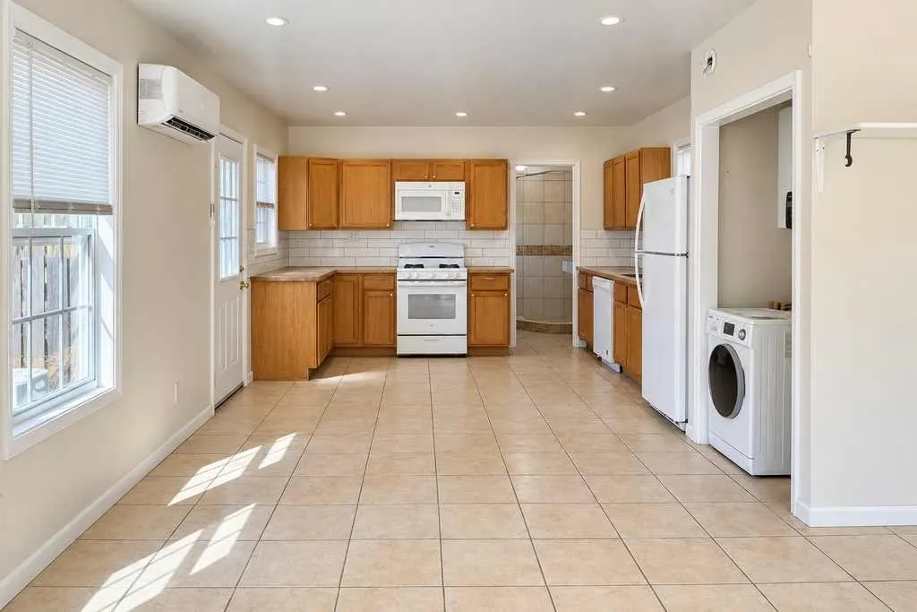 Kitchen and living areas flow together beneath recessed lighting with abundant natural light.