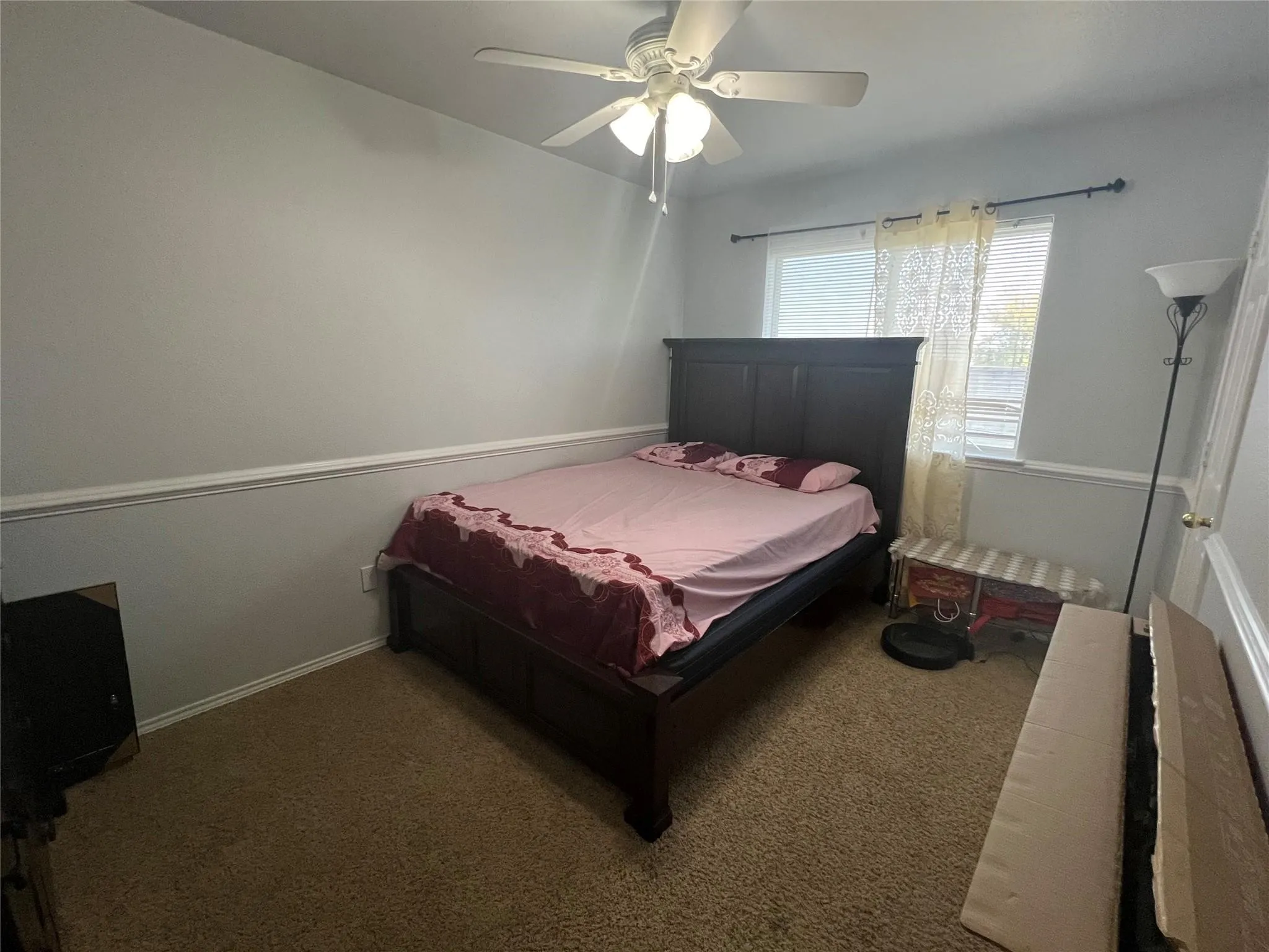 Ceiling fan with integrated lighting, wall trim, window with blinds, and carpeted flooring