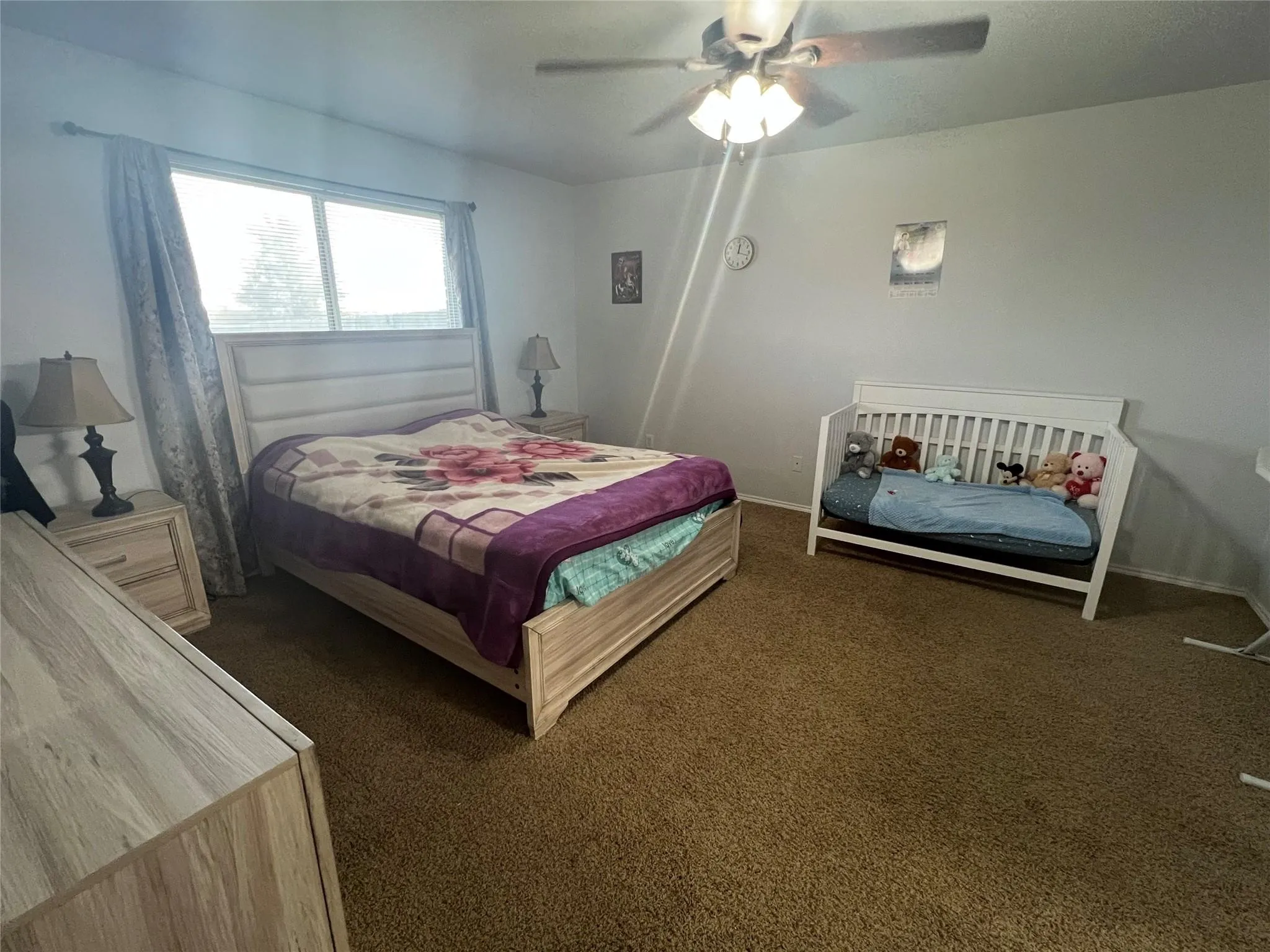 Vaulted ceiling with recessed lighting, fireplace with white brick surround, ceiling fan with integrated lighting, and light-toned tile flooring
