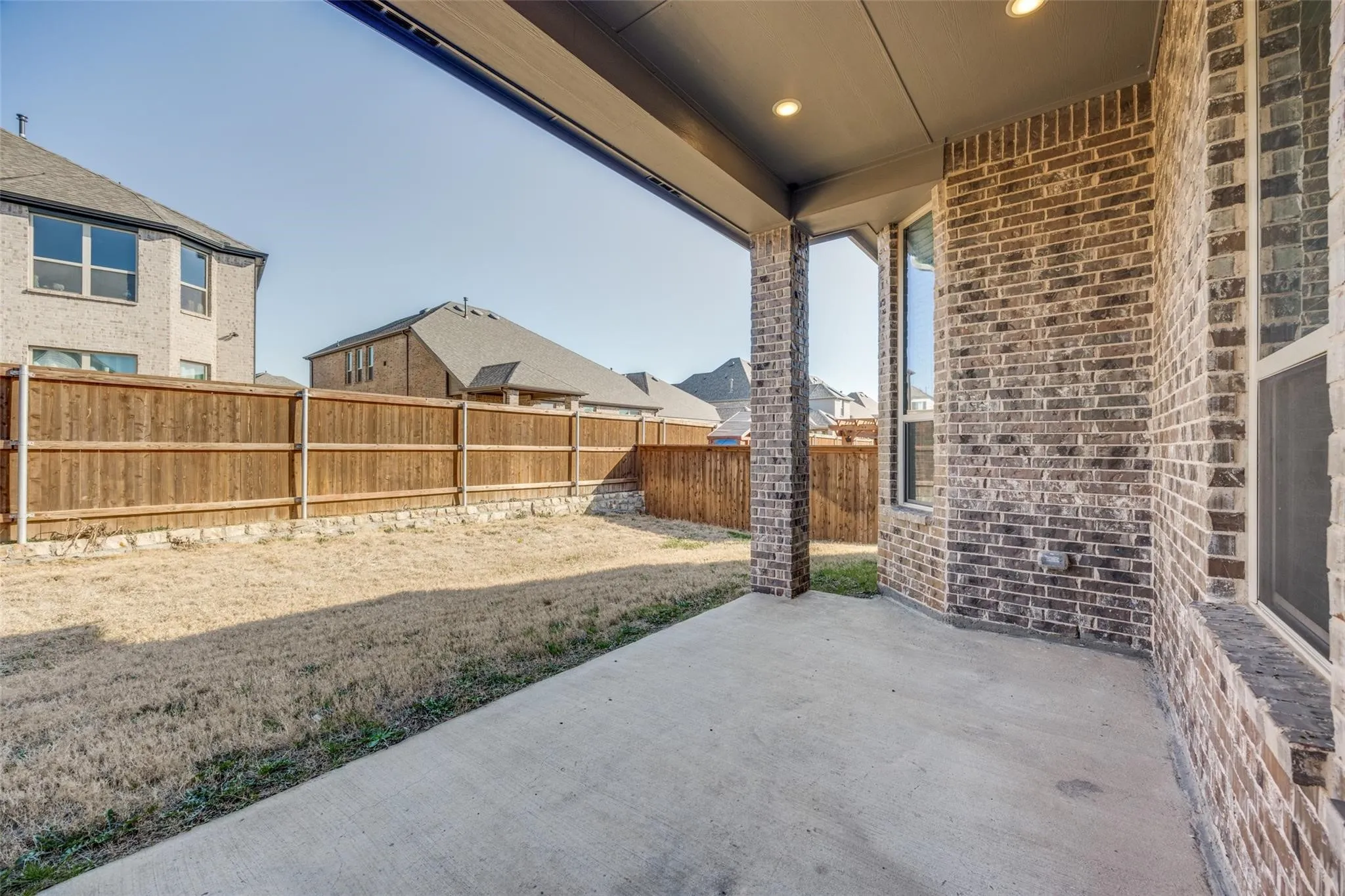Fenced backyard featuring a patio