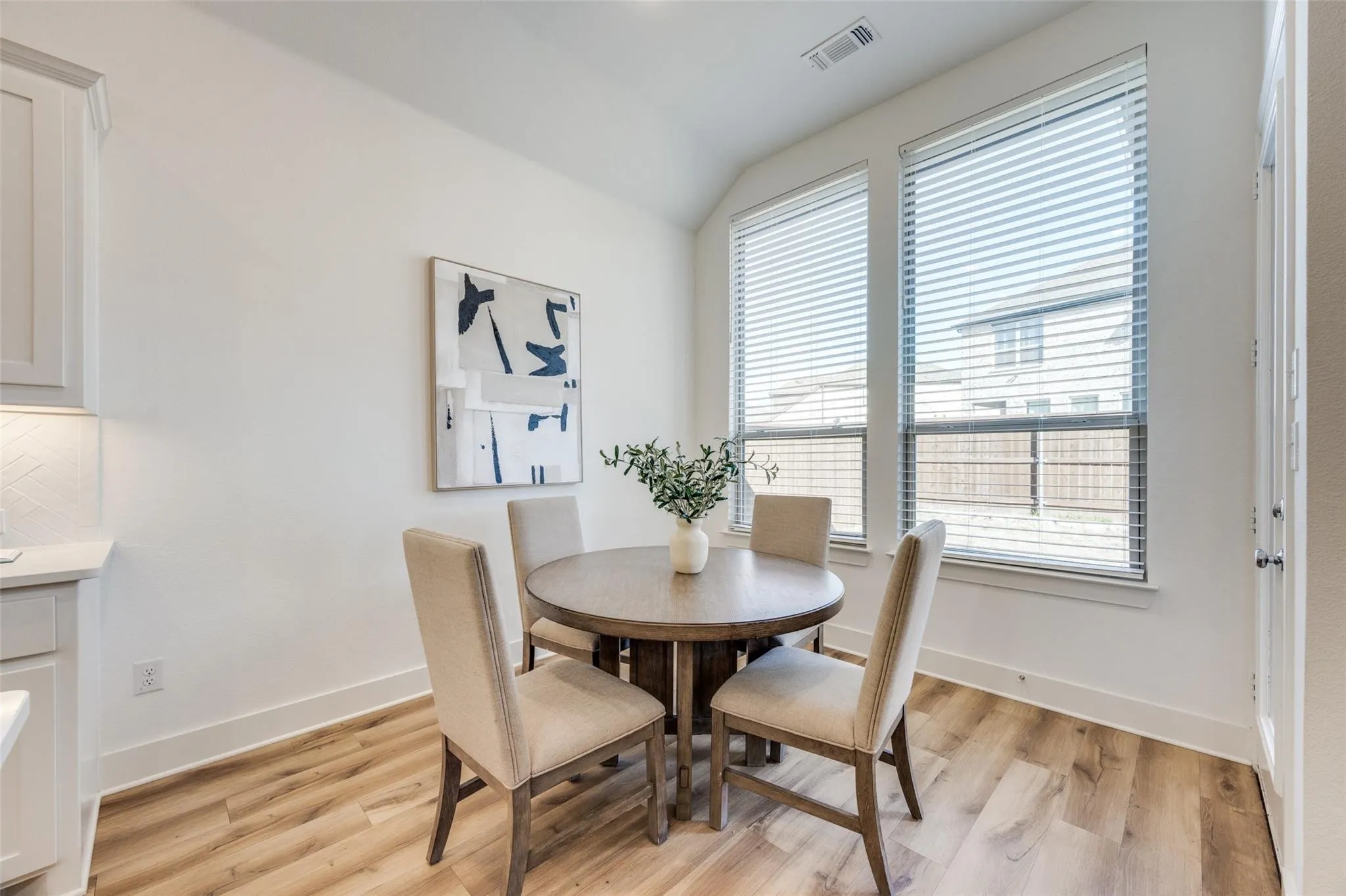 Dining space featuring lofted ceiling and light wood finished floors