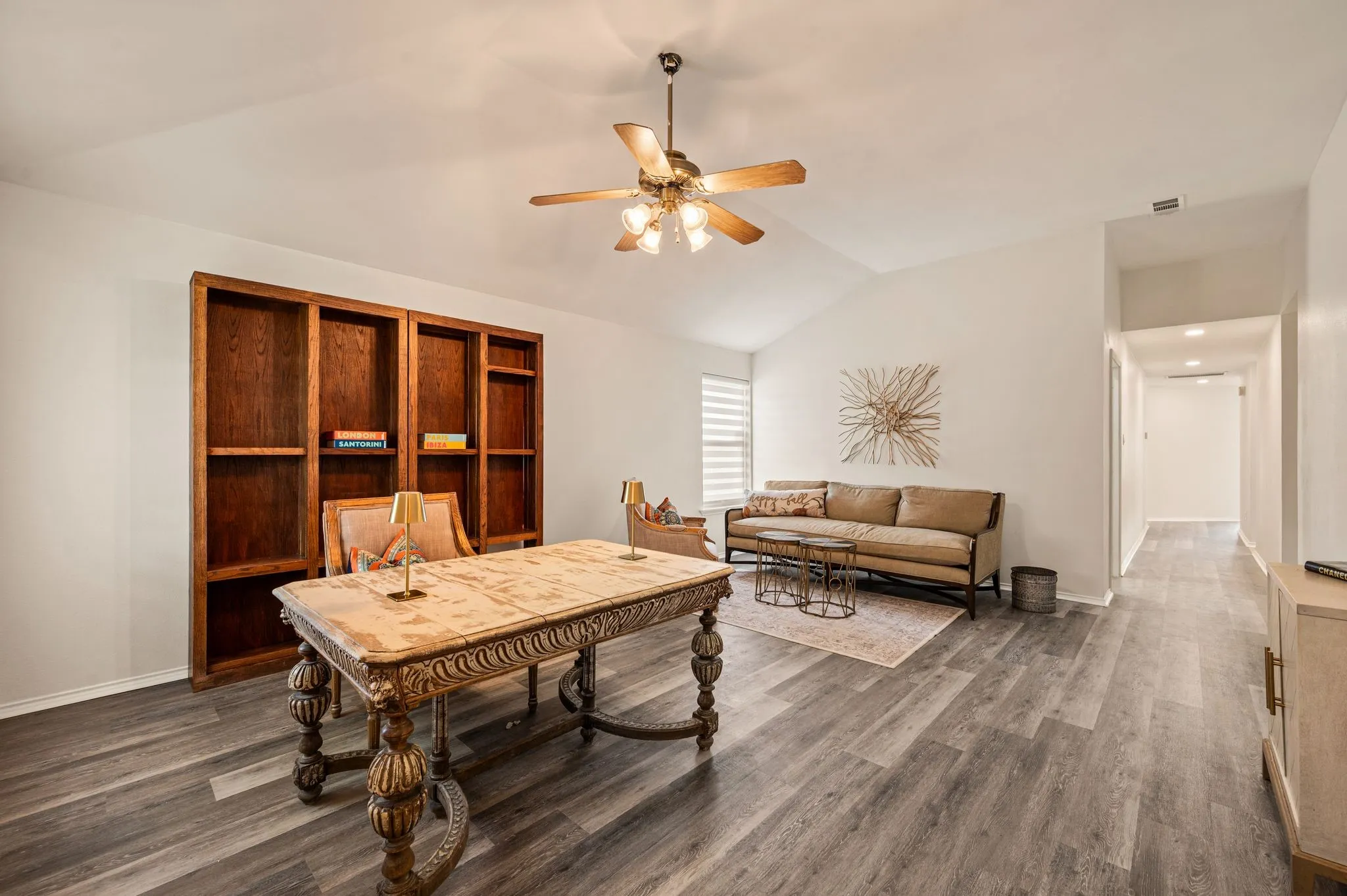 Vaulted ceiling with a ceiling fan, wood-finish flooring, built-in wooden shelving, and recessed lighting