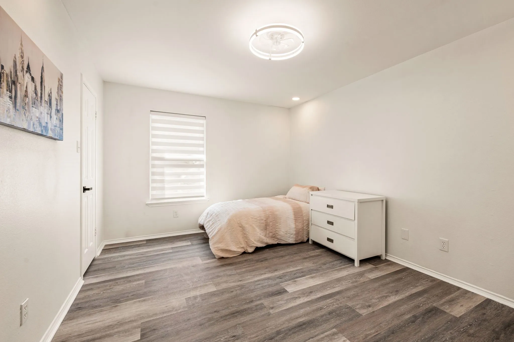 Wood-finish flooring, recessed lighting, and a flush-mount ceiling fixture