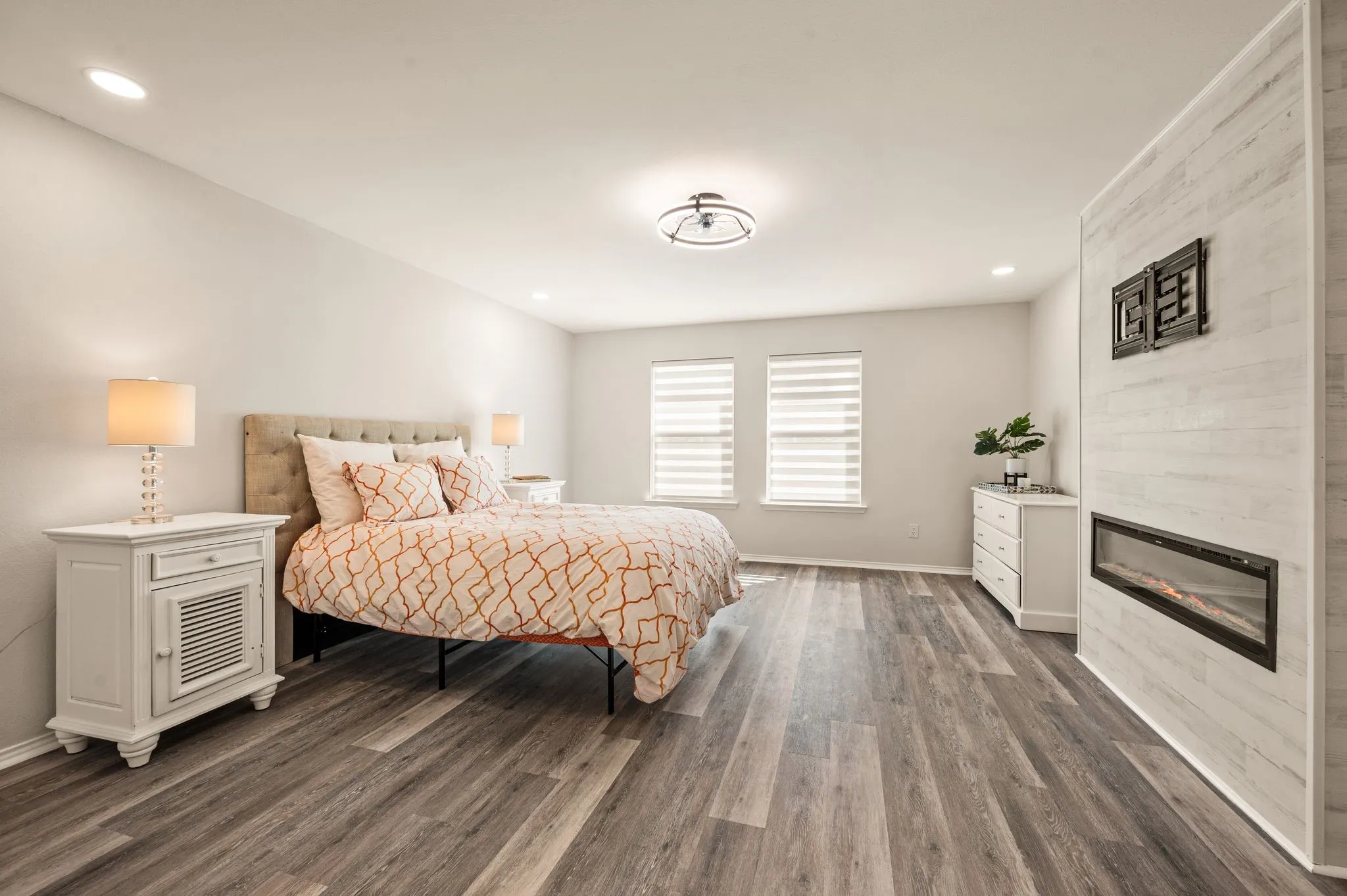 Wood-finish flooring, recessed lighting, and a modern ceiling fixture