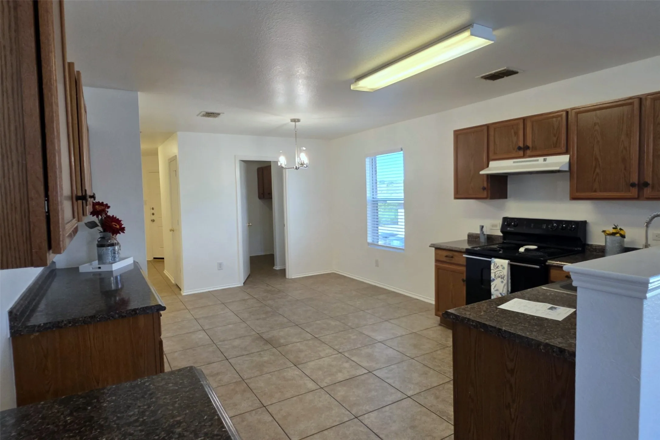 Entry hallway leads to the kitchen and dining nook.
