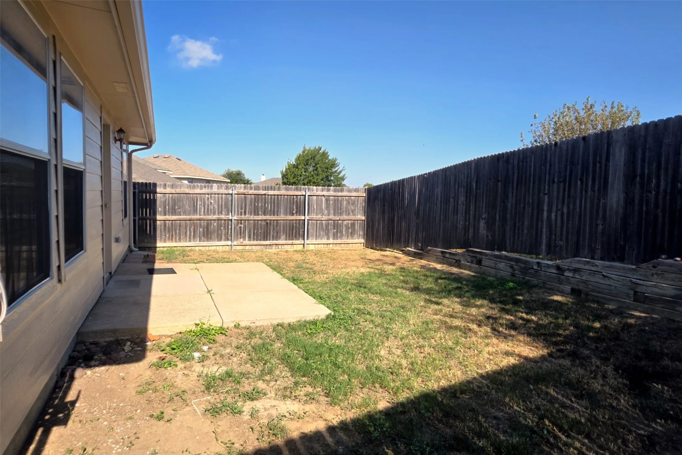 Retaining walls increase the privacy in the fenced backyard.