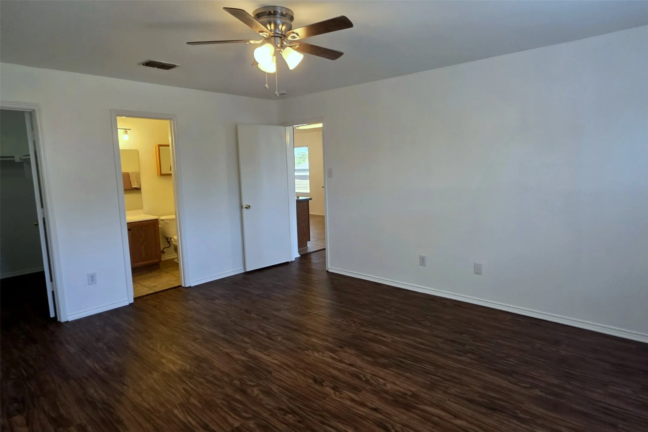 Primary suite located near the living room and kitchen.