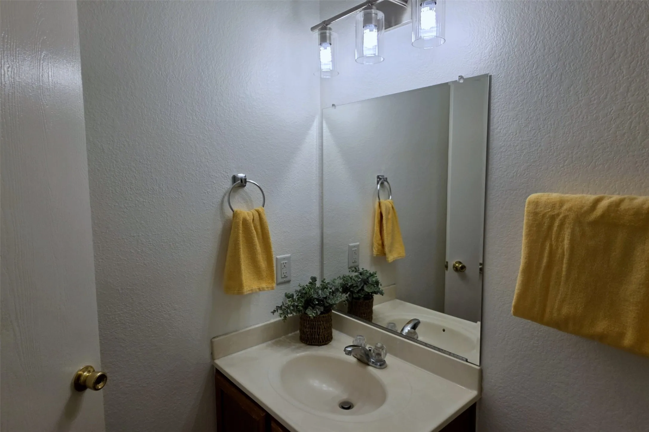 Hall bathroom has a storage vanity, new lighting and freshly painted!
