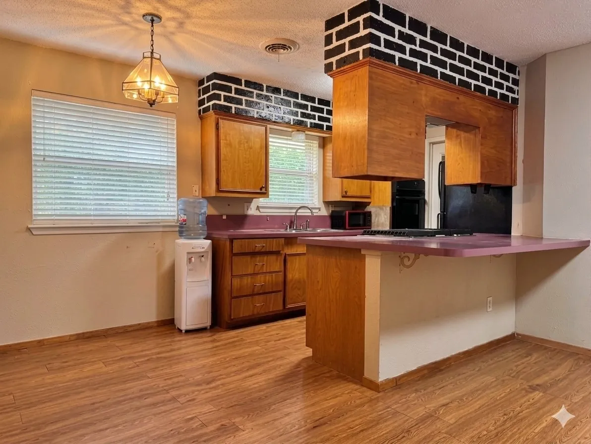 Kitchen with wood-finish flooring, wood cabinetry, and a peninsula countertop