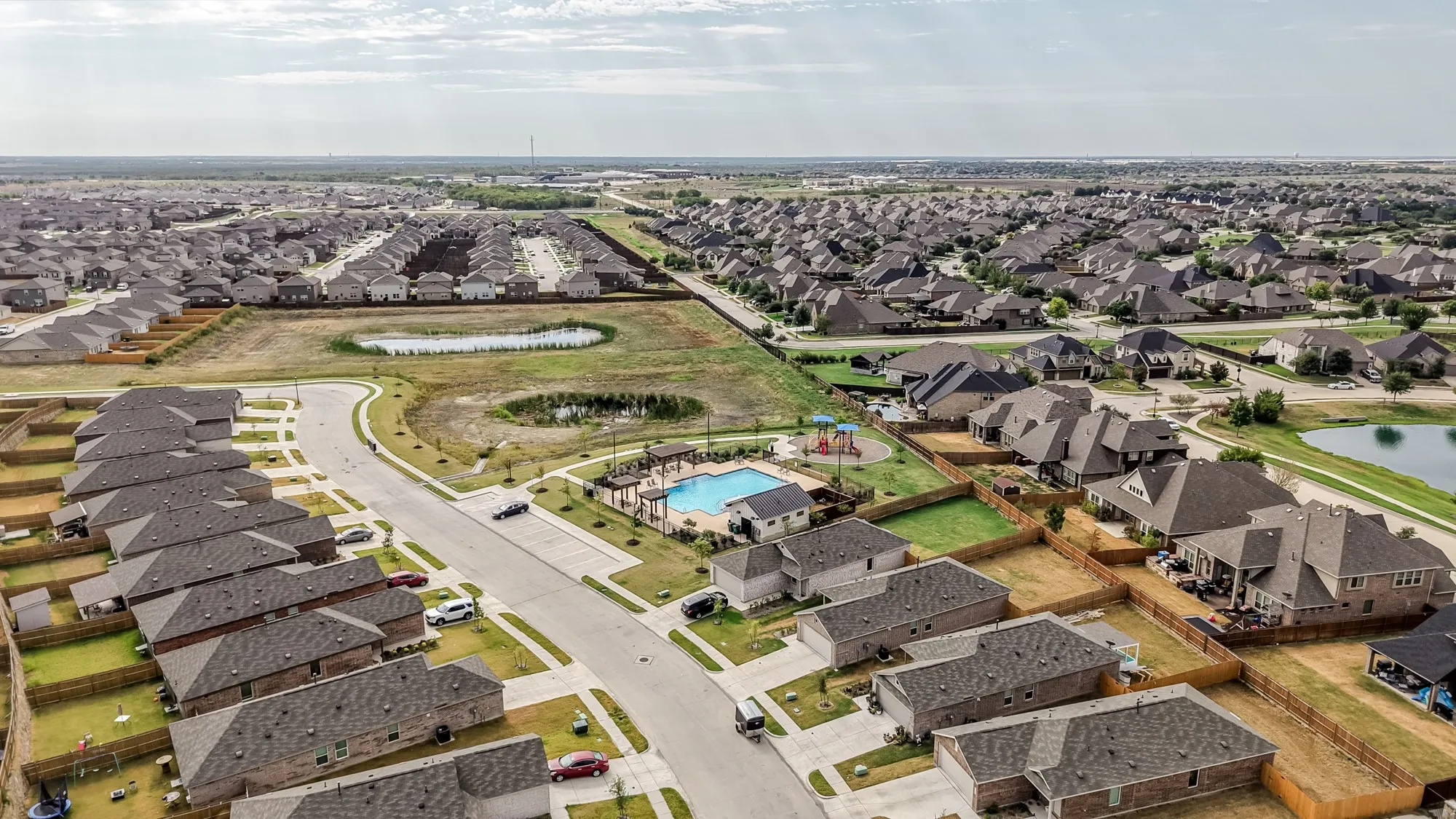 Neighborhood featuring residential streets, a community pool, a playground, and multiple ponds