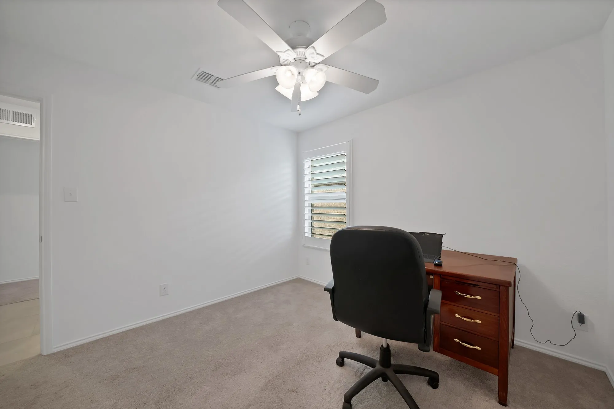 Recessed lighting, ceiling fan, white wall finishes, plush carpet flooring, and window with plantation shutters