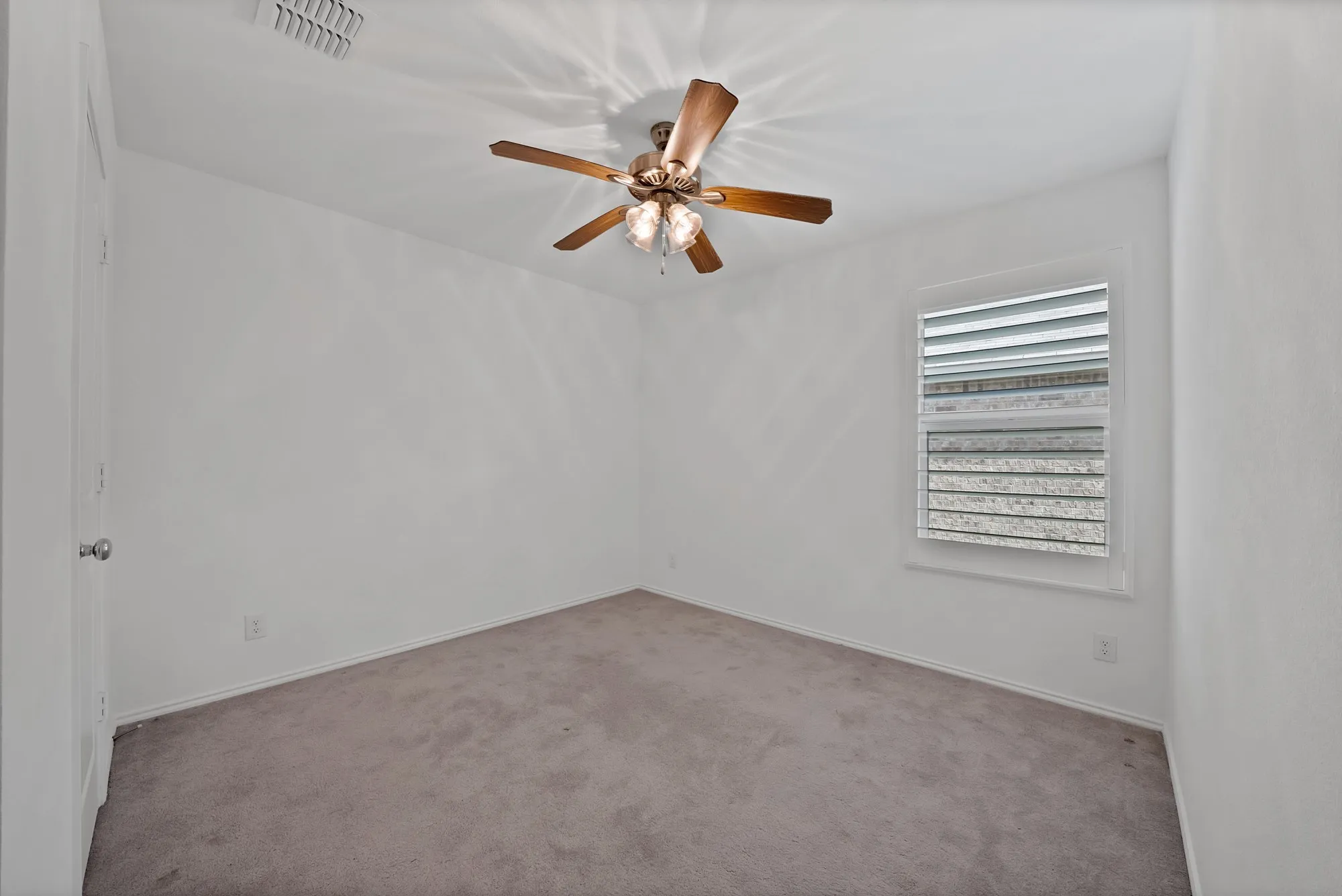 Neutral wall color complemented by carpet flooring