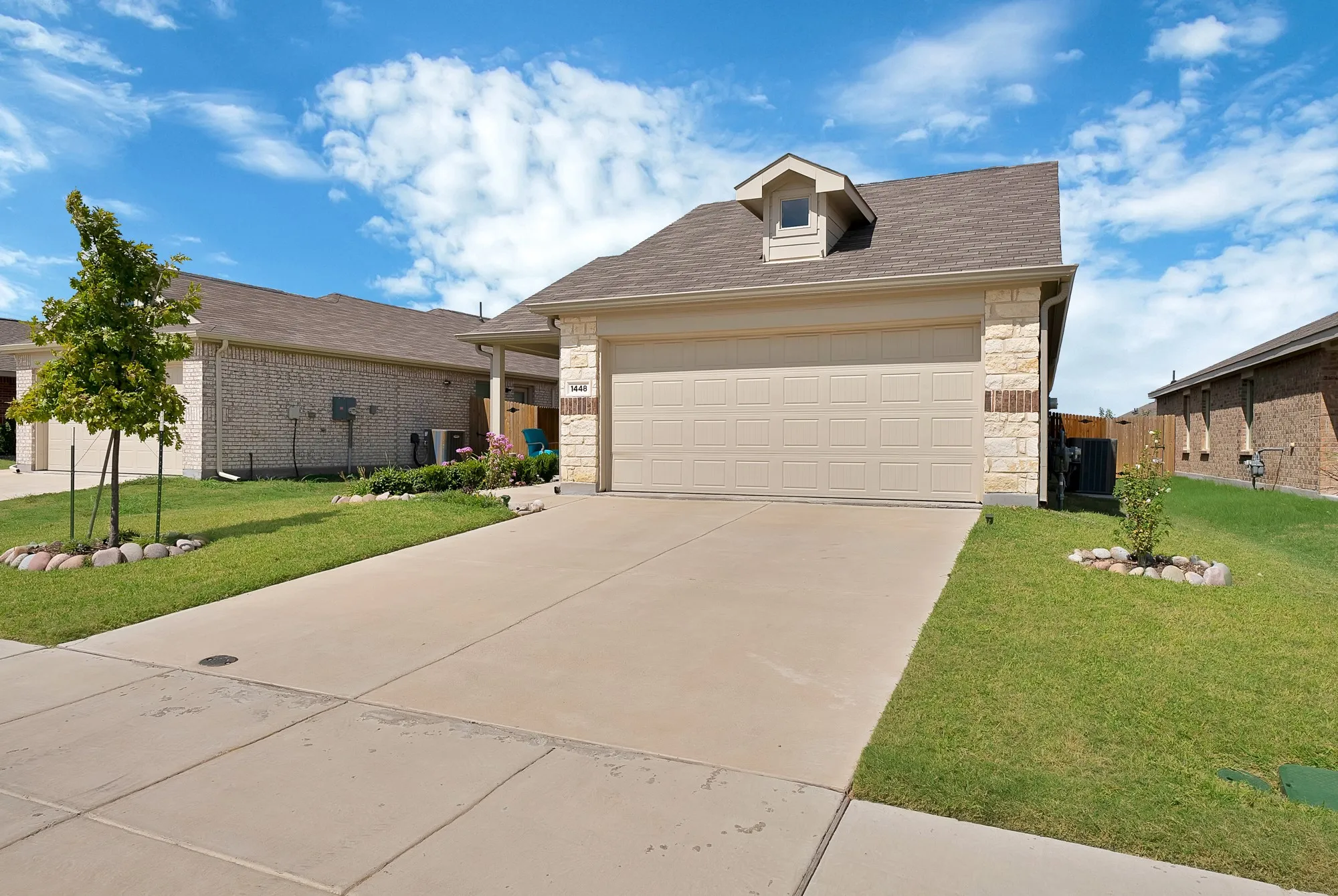 Front exterior featuring a concrete driveway and an attached garage
