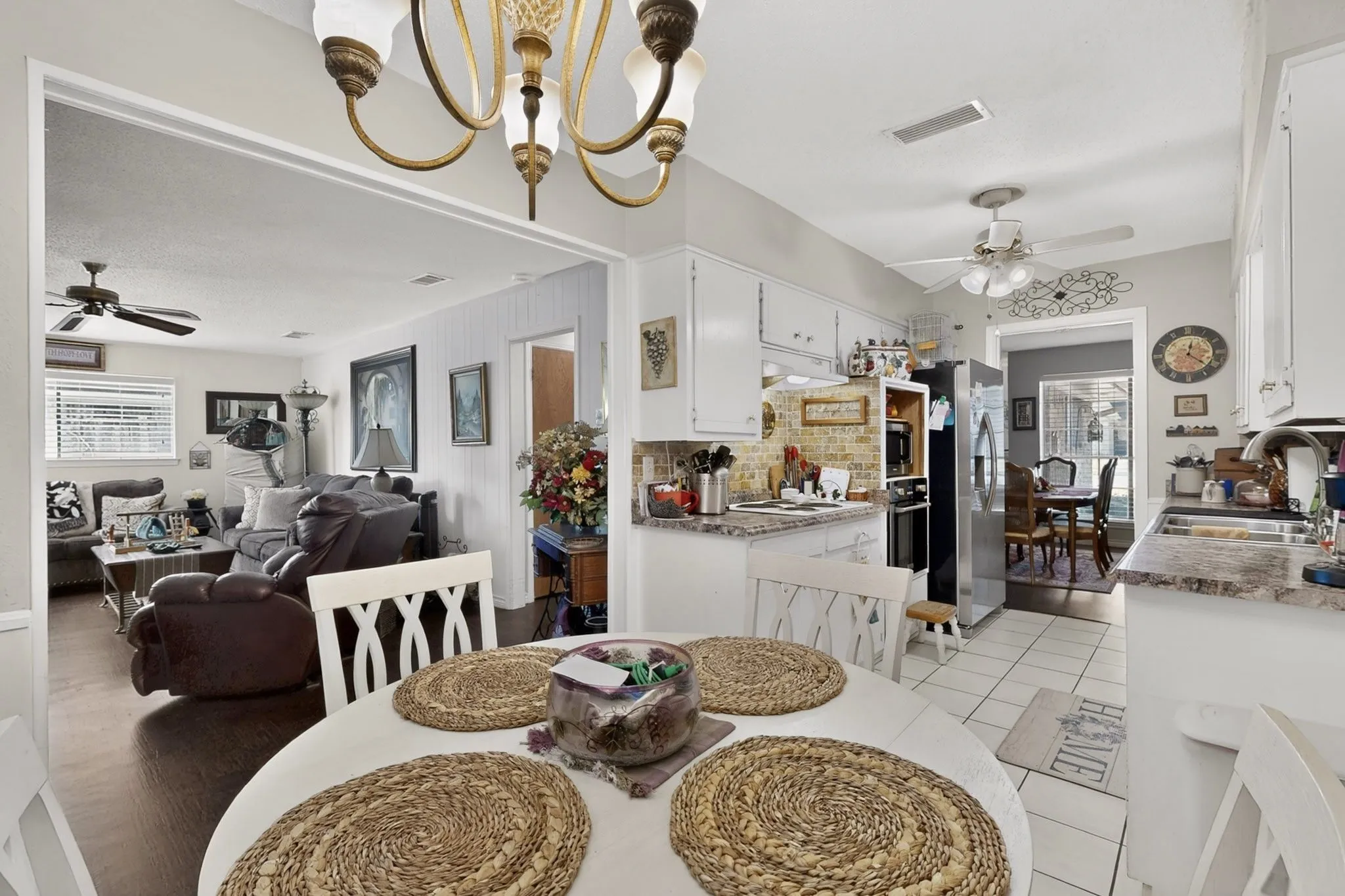 Kitchen featuring white cabinetry, stone-finish countertops, and a tile floor