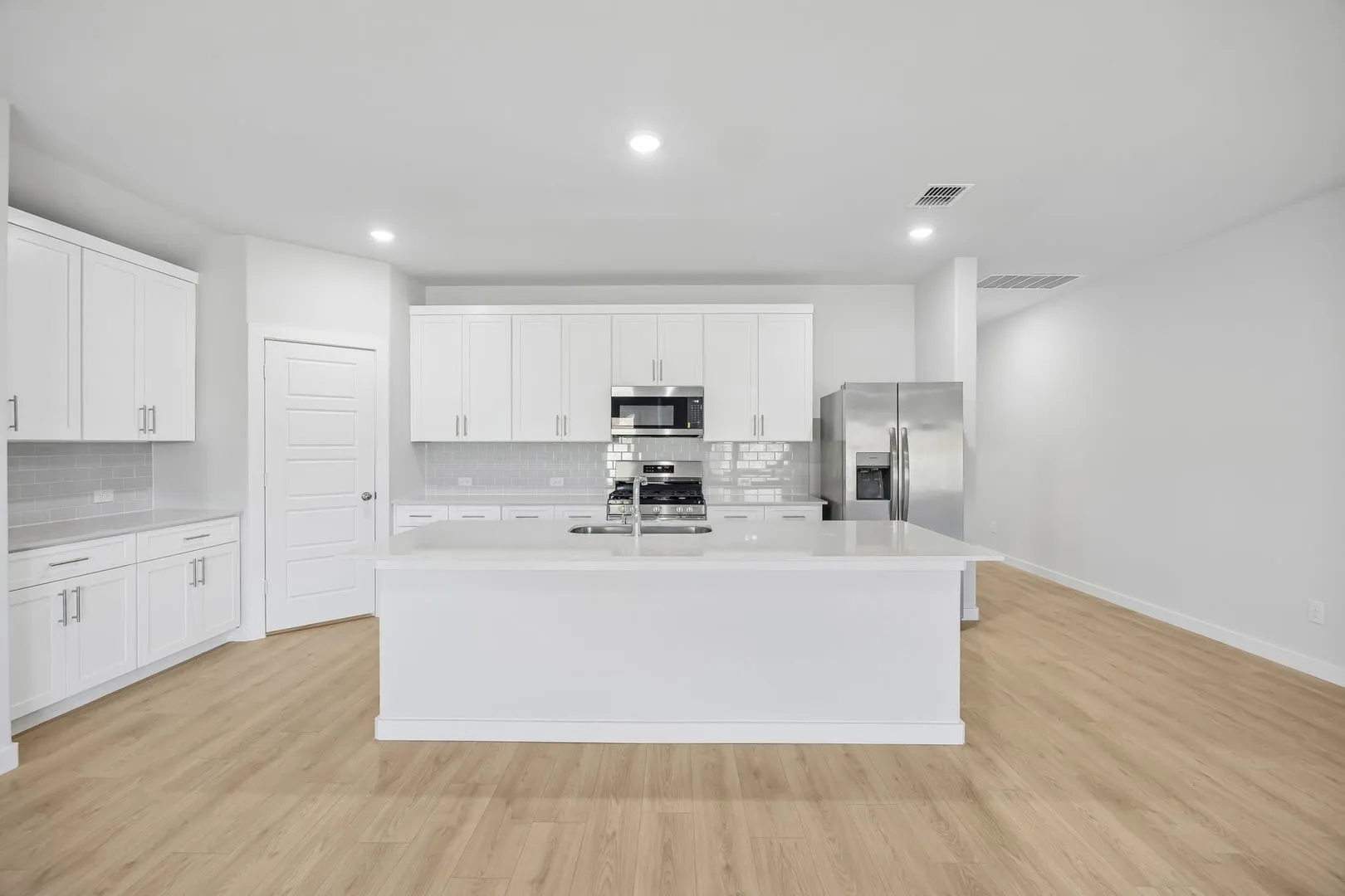 Kitchen in the Heisman home plan by Trophy Signature Homes – REPRESENTATIVE PHOTO