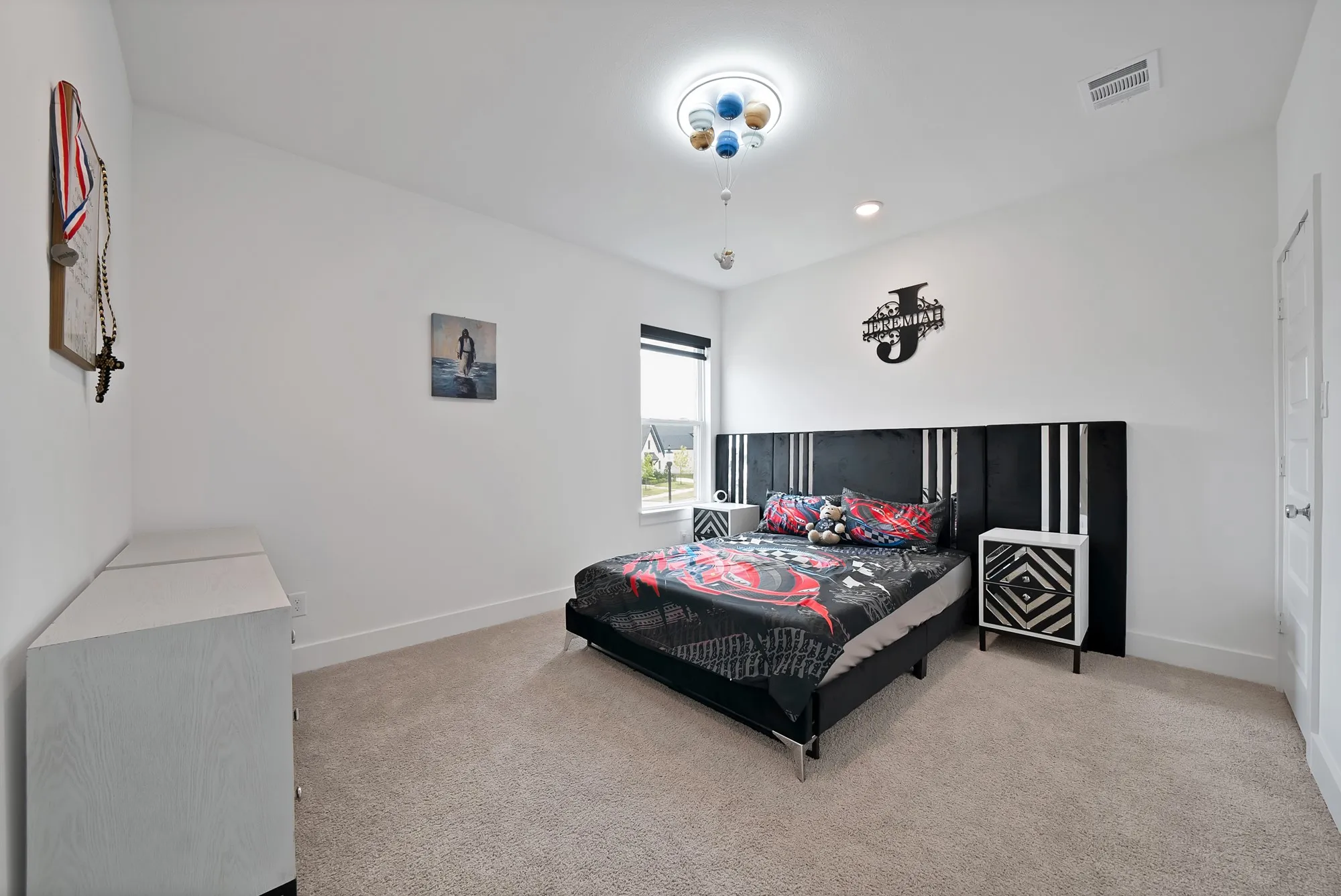 Plush carpet flooring, a large window, recessed lighting, and a contemporary ceiling fixture