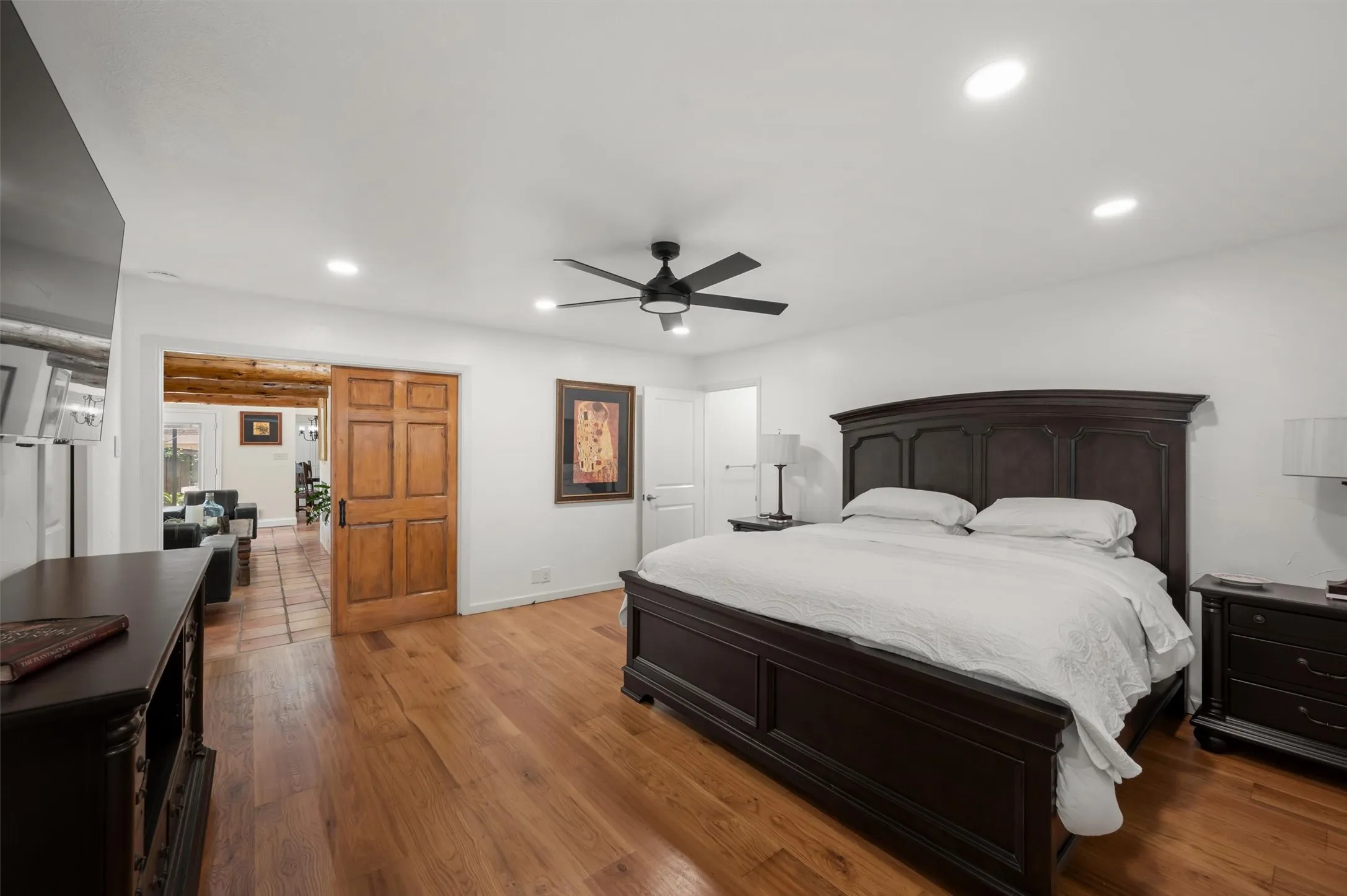 Recessed lighting, wood-finish flooring, ceiling fan, and a wood sliding barn door