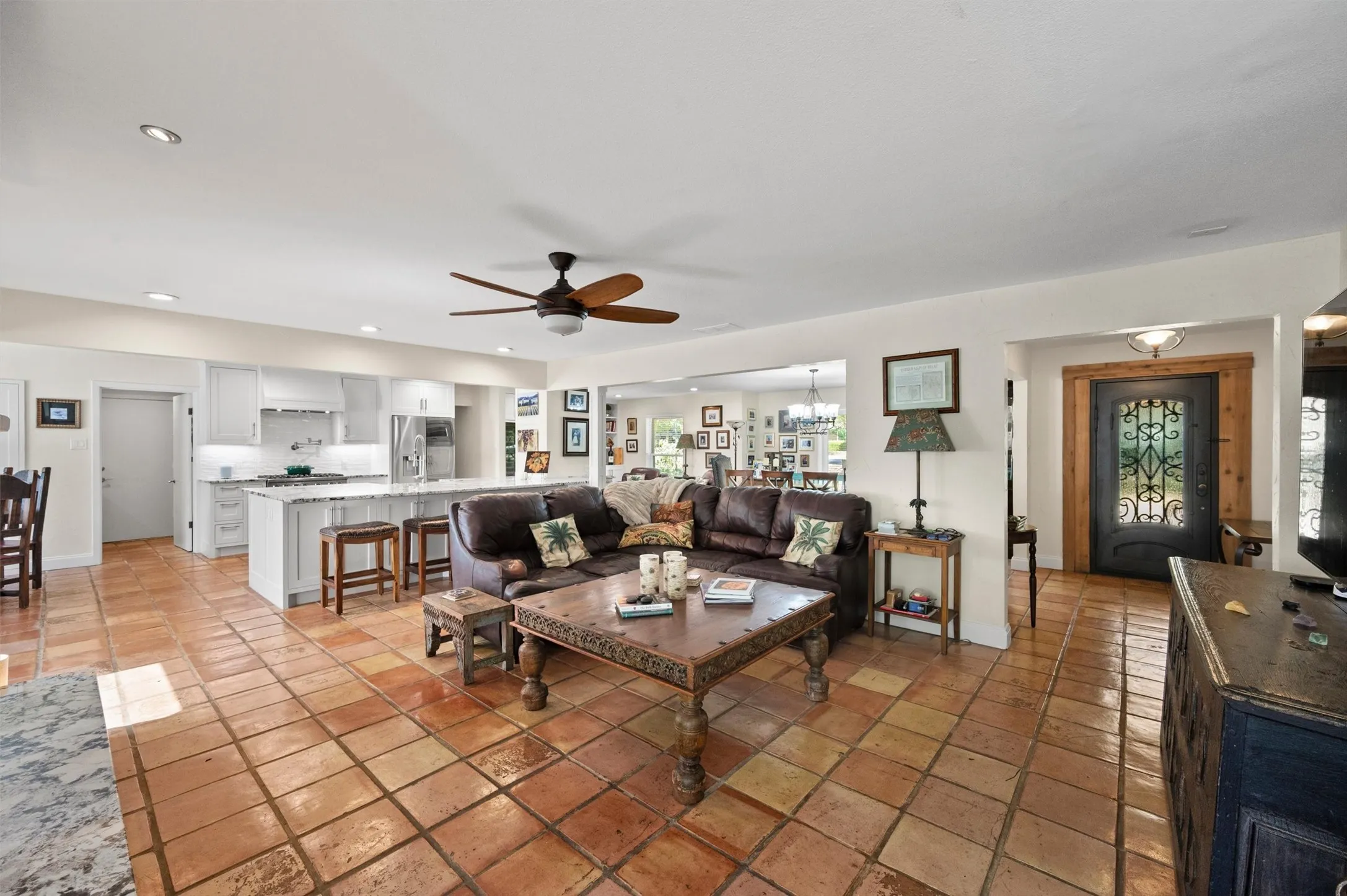 Terracotta tile flooring, recessed lighting, and a ceiling fan