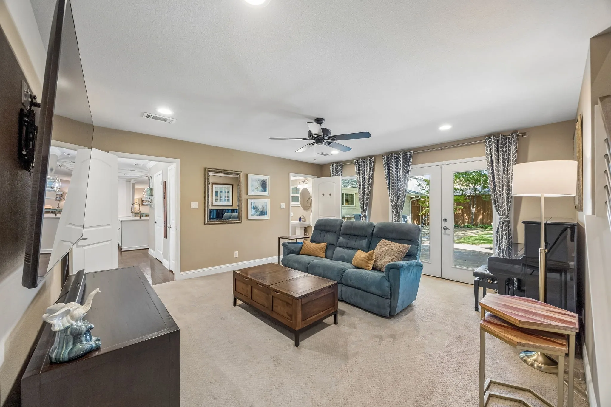Downstairs second iving room will french doors overlooking backyard