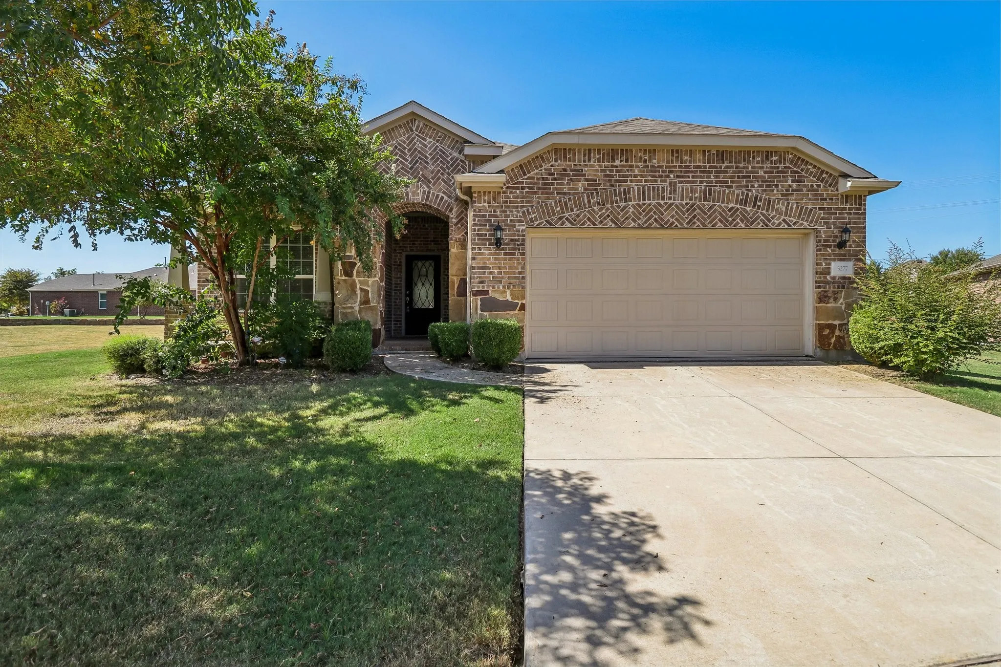 Brick and stone exterior with an arched entry