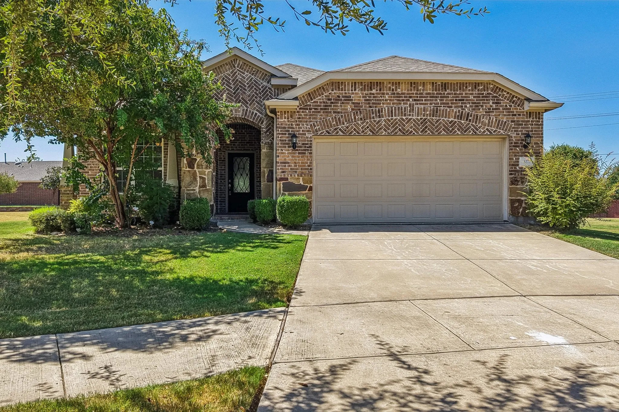 Brick and stone exterior with an arched entryway