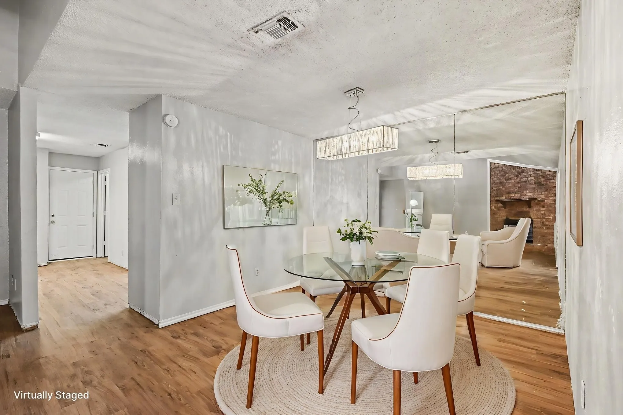 Wood-finish flooring throughout, complemented by a rectangular chandelier