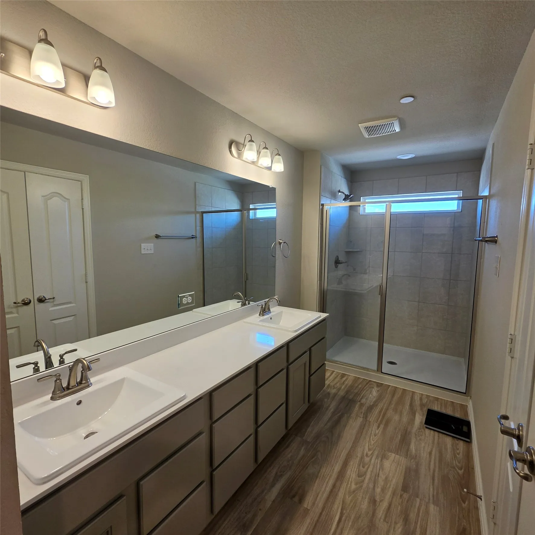 Dual sinks, toilet has a door for privacy