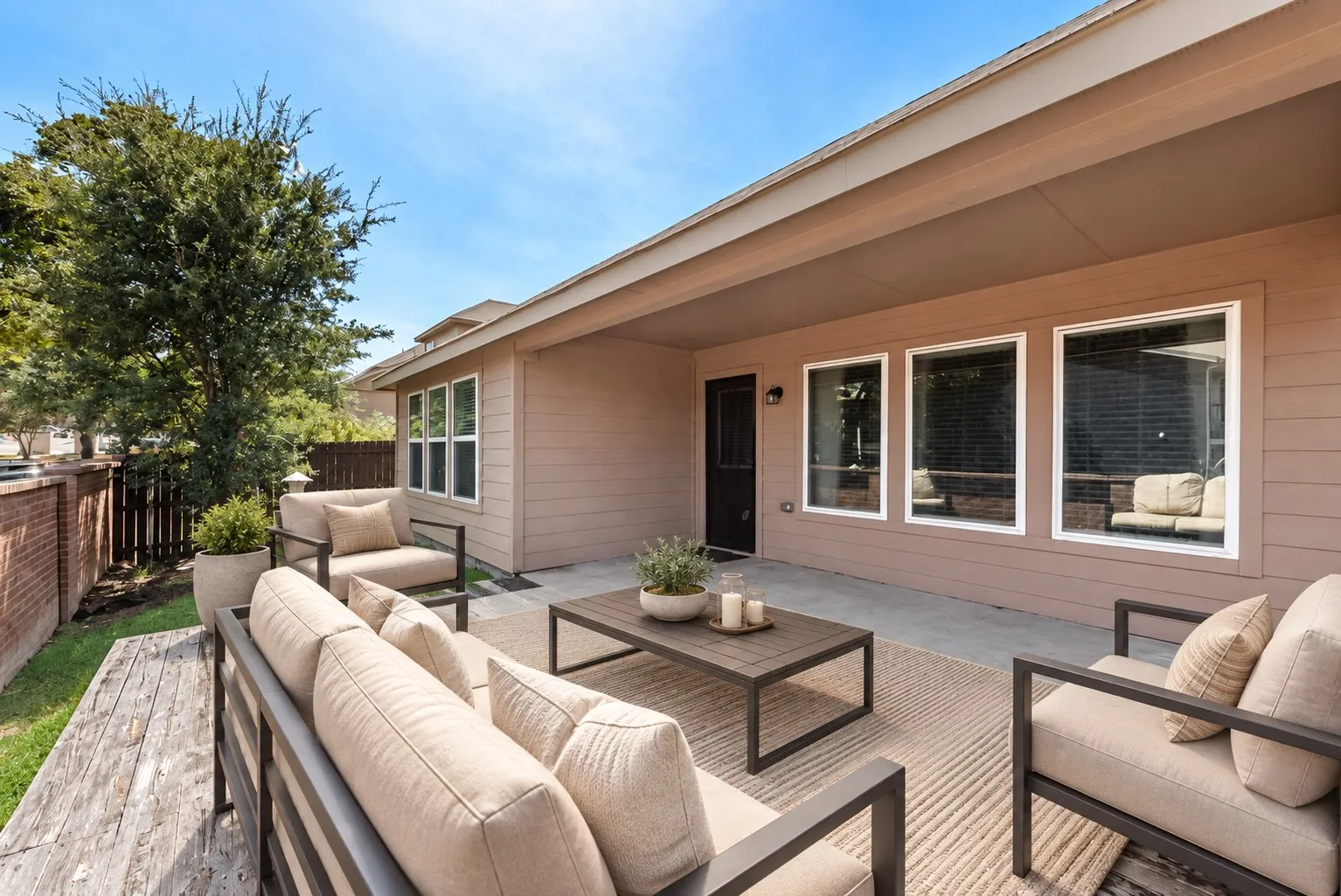Covered patio with a concrete surface and access to a grass area