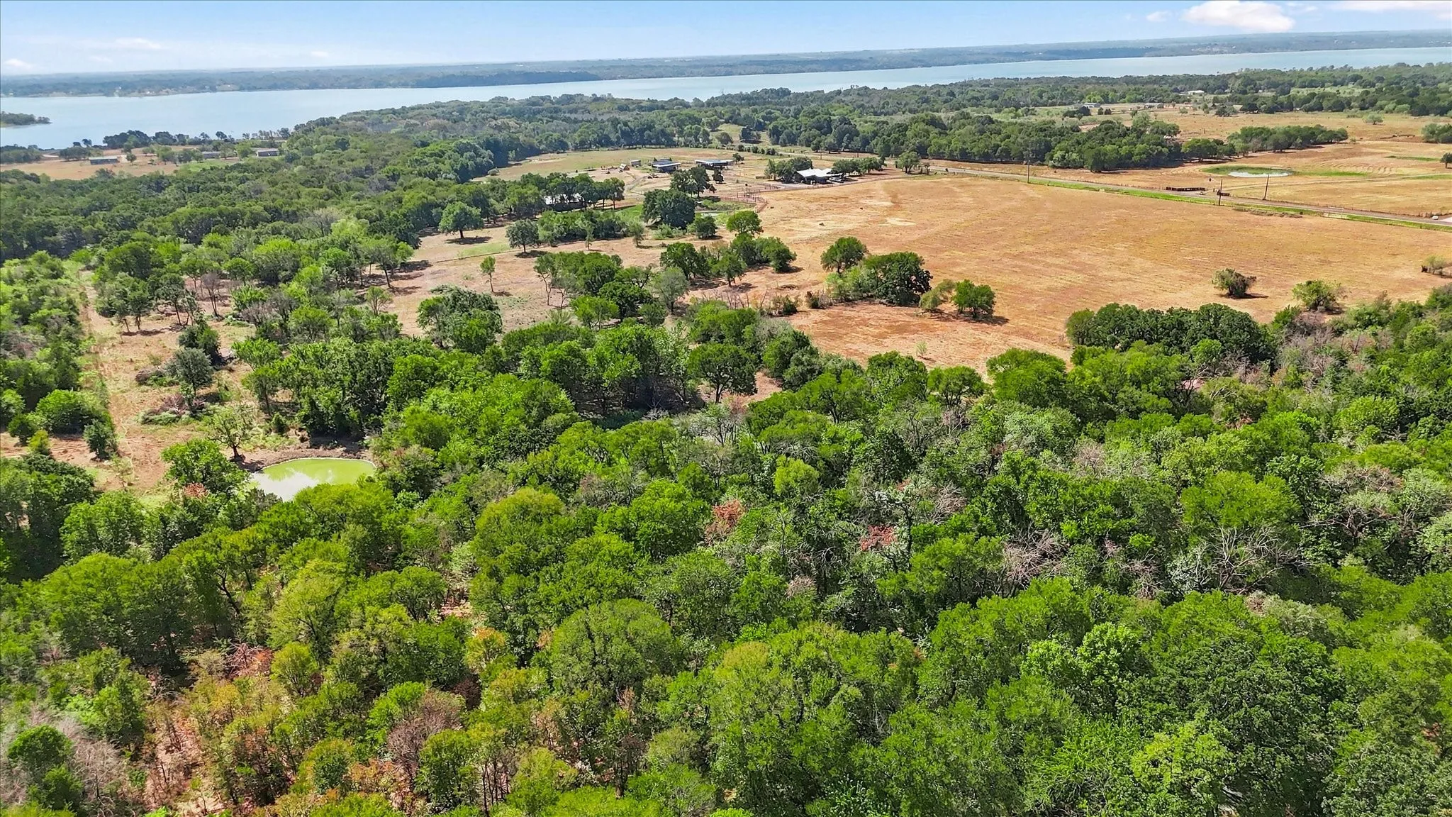 View from the back/east side of the property, looking south. Neighbor pond is not on this property.