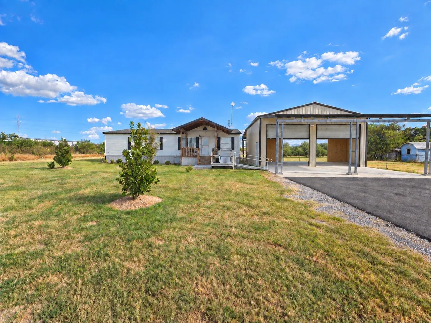 Single-story residence featuring a covered front porch and a paved driveway