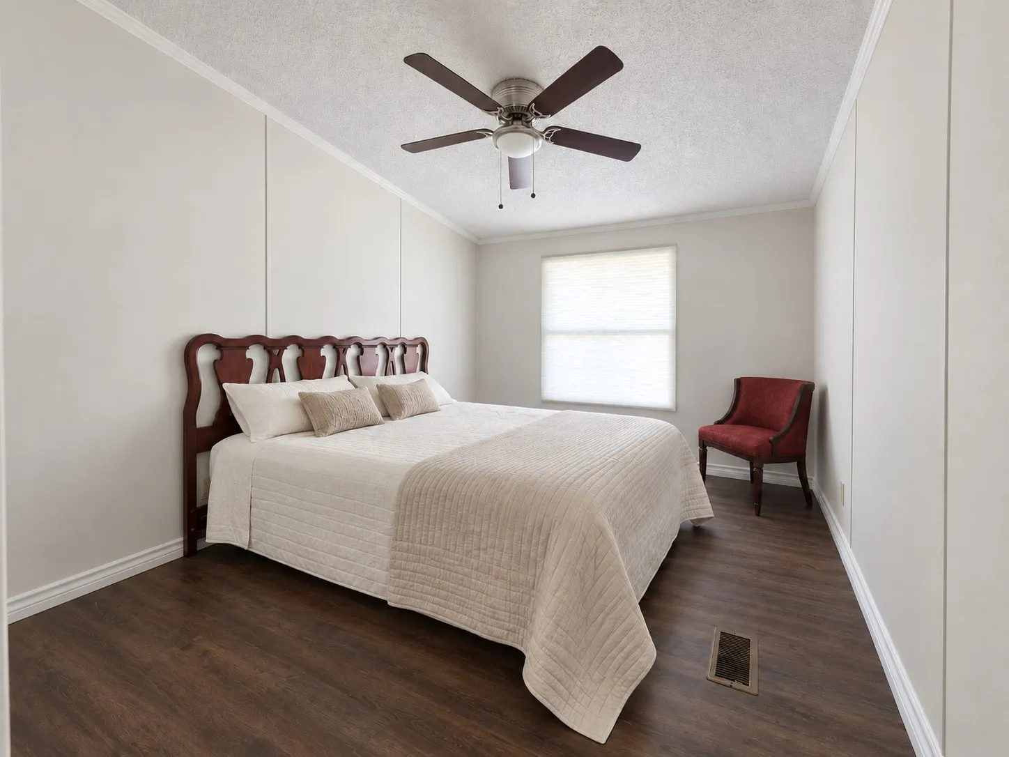 Wood-finish flooring, ceiling fan with integrated lighting, window with blinds, and paneled walls