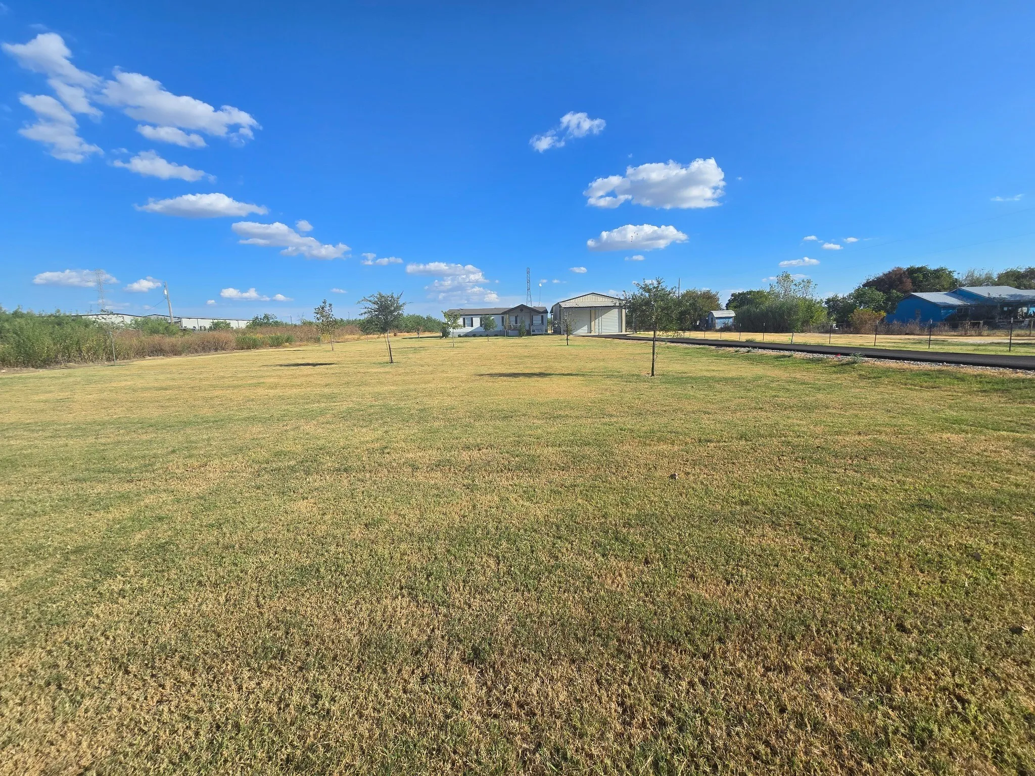 Expansive front lot with a grass field