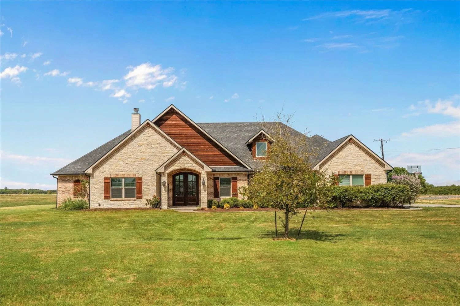 Brick and wood-sided exterior with a gabled roofline