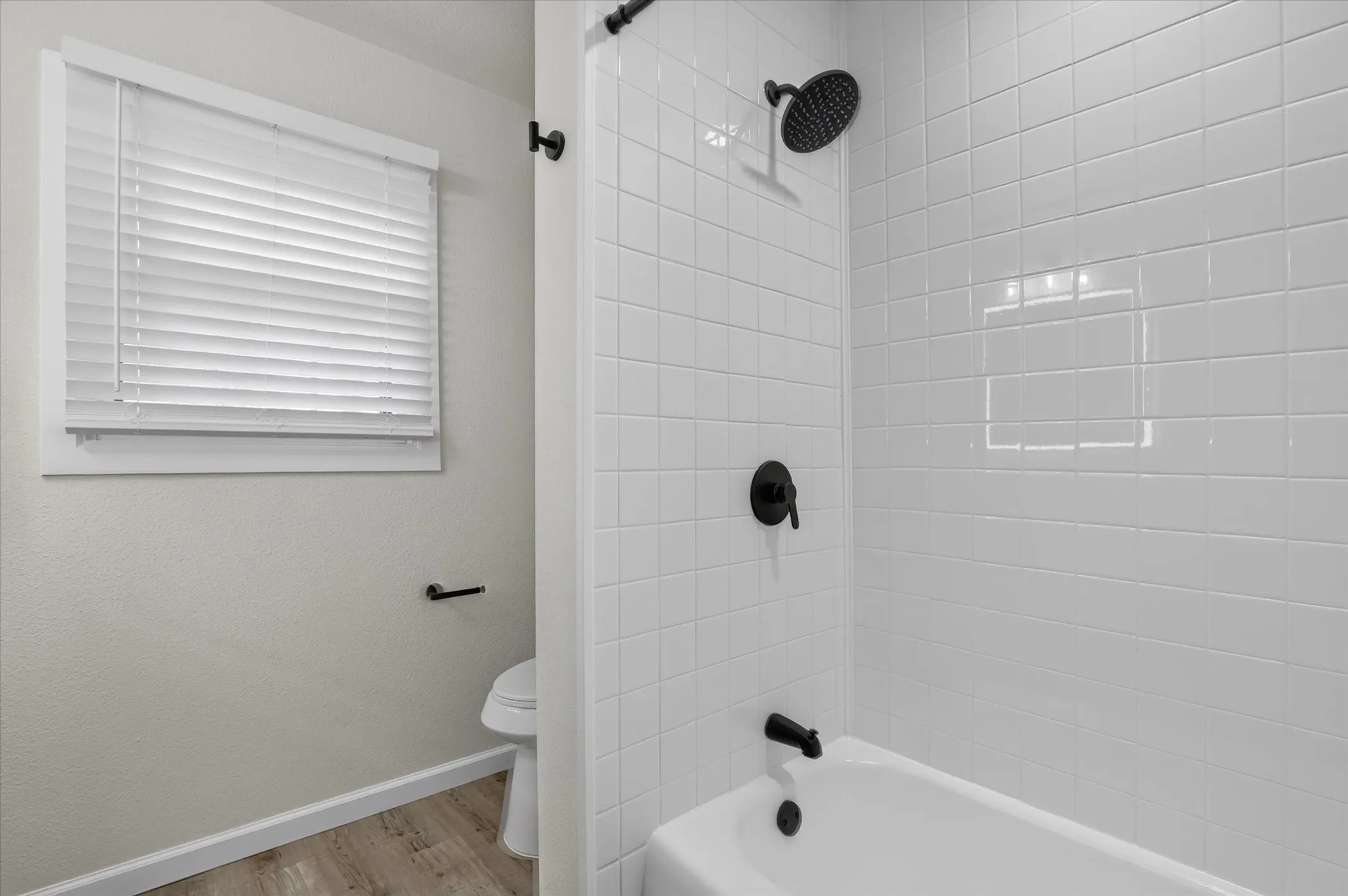 White subway tile shower surround with matte black fixtures