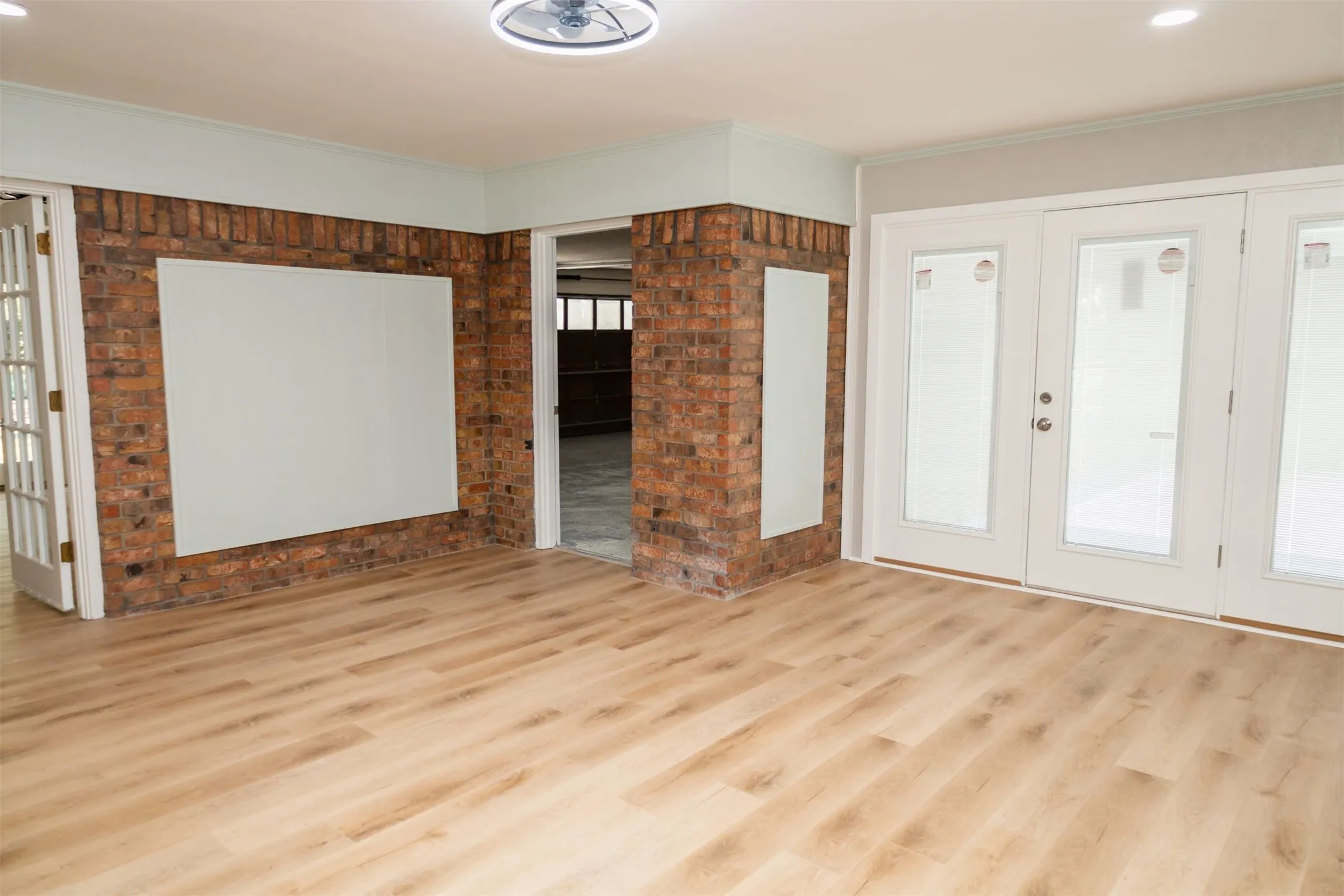 The den has direct access to the backyard patio, garage, living room, utility room, & primary bedroom