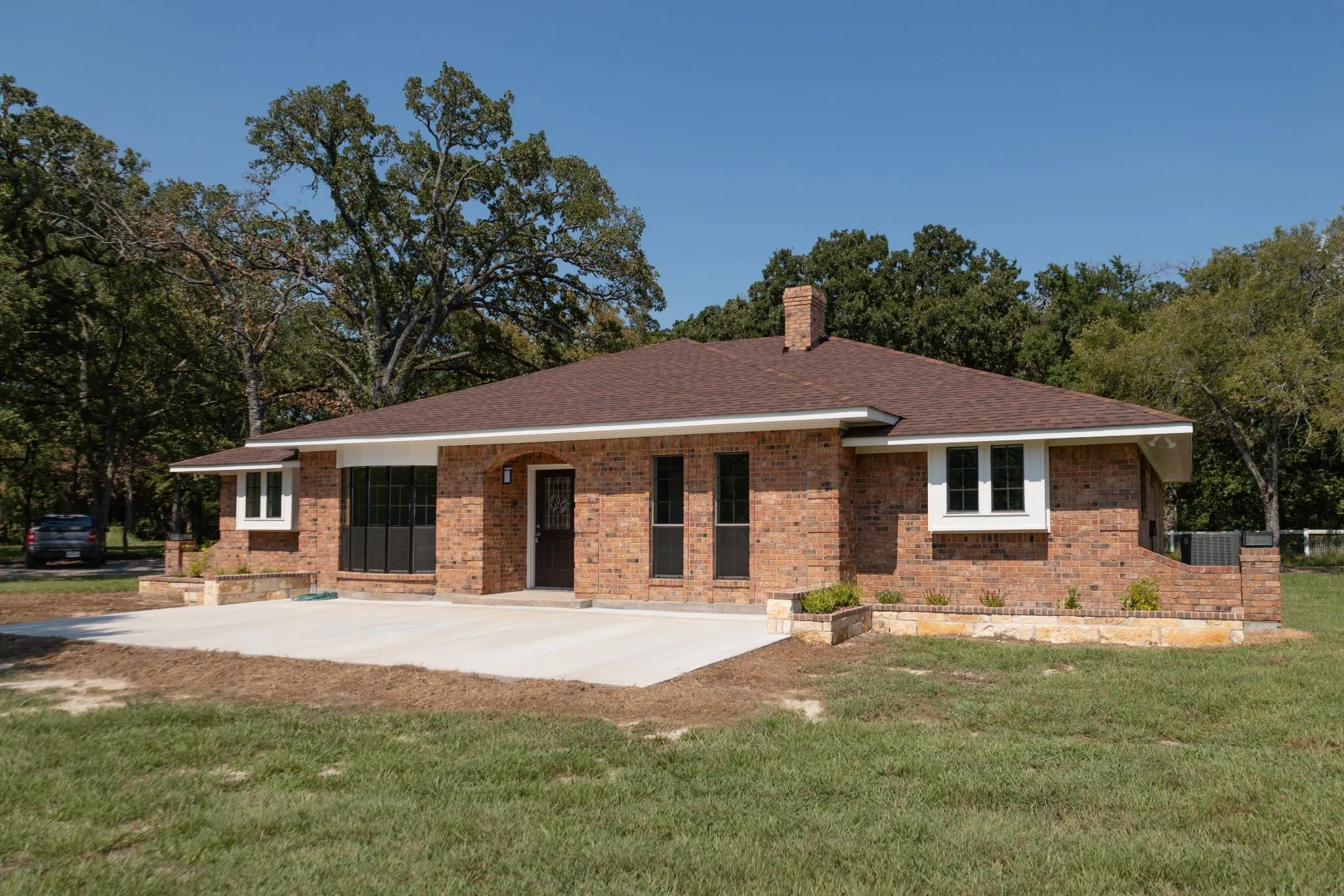 Front of house with new patio, custom stone planters, new roof and so much more!