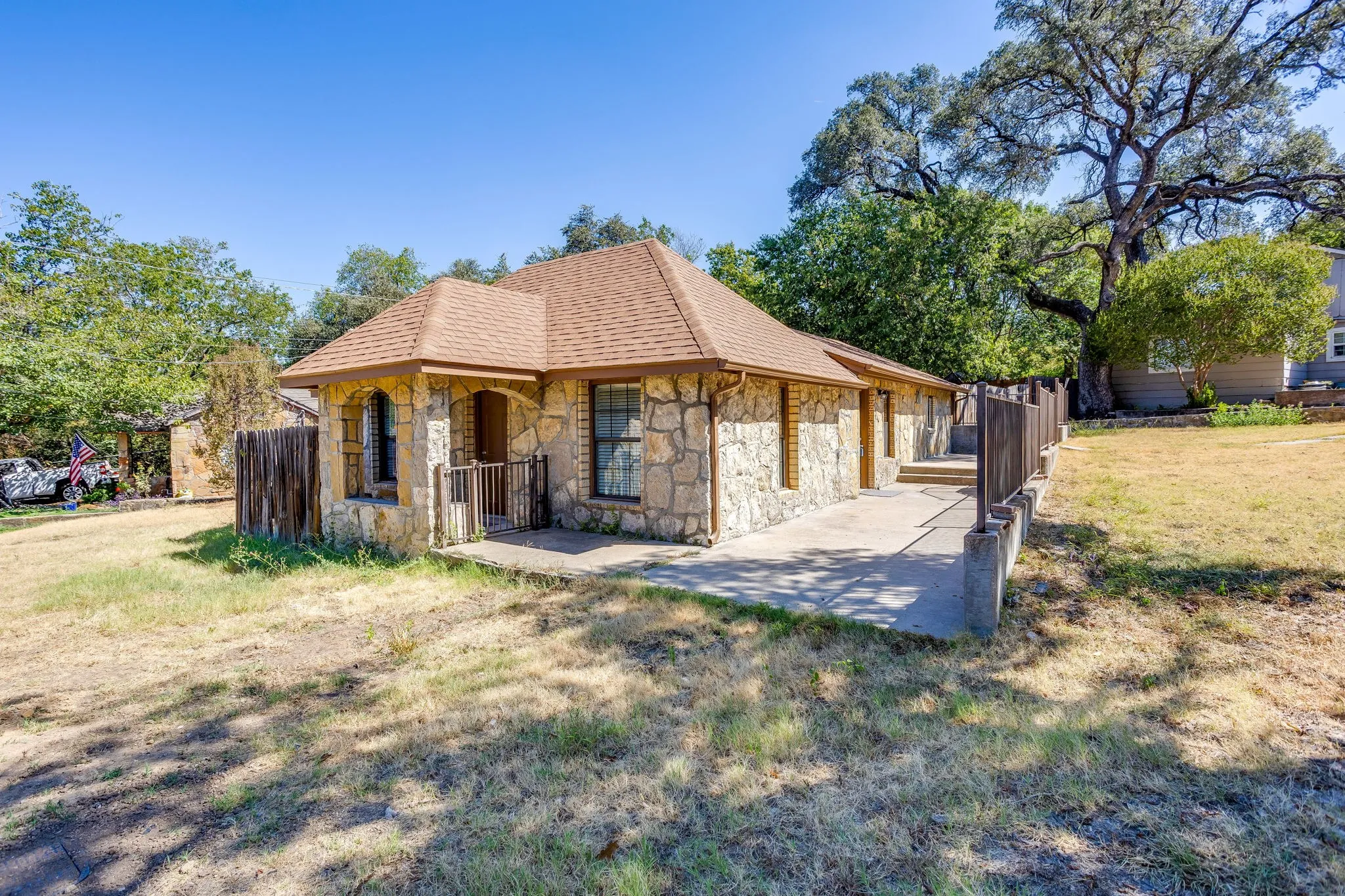 Stone exterior with a shingled roof