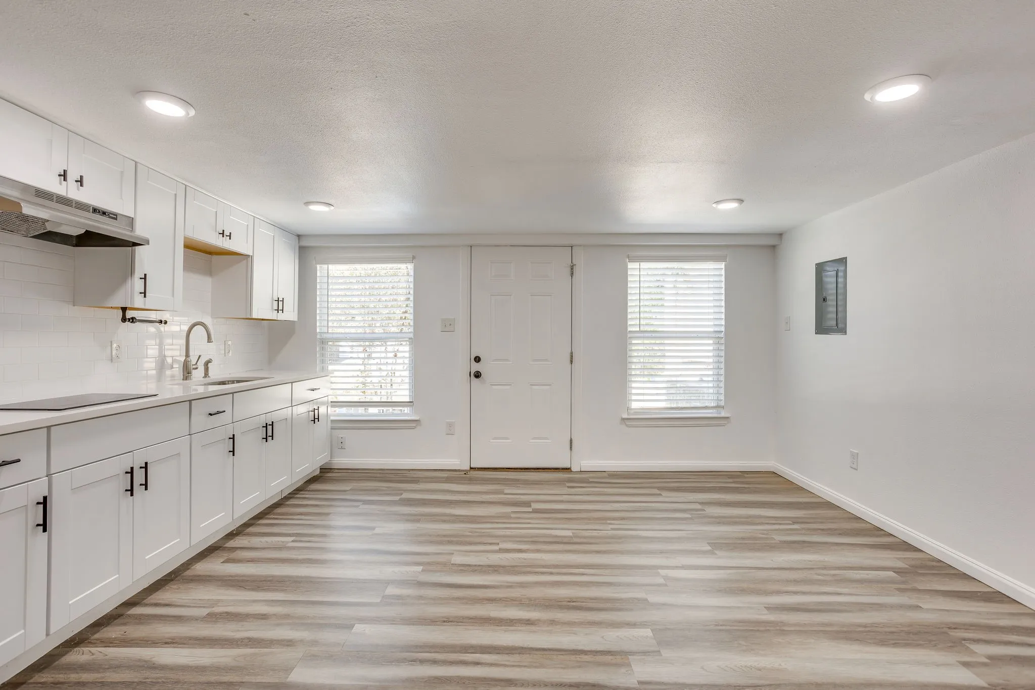 Bright interior featuring recessed lighting and wood-finish flooring