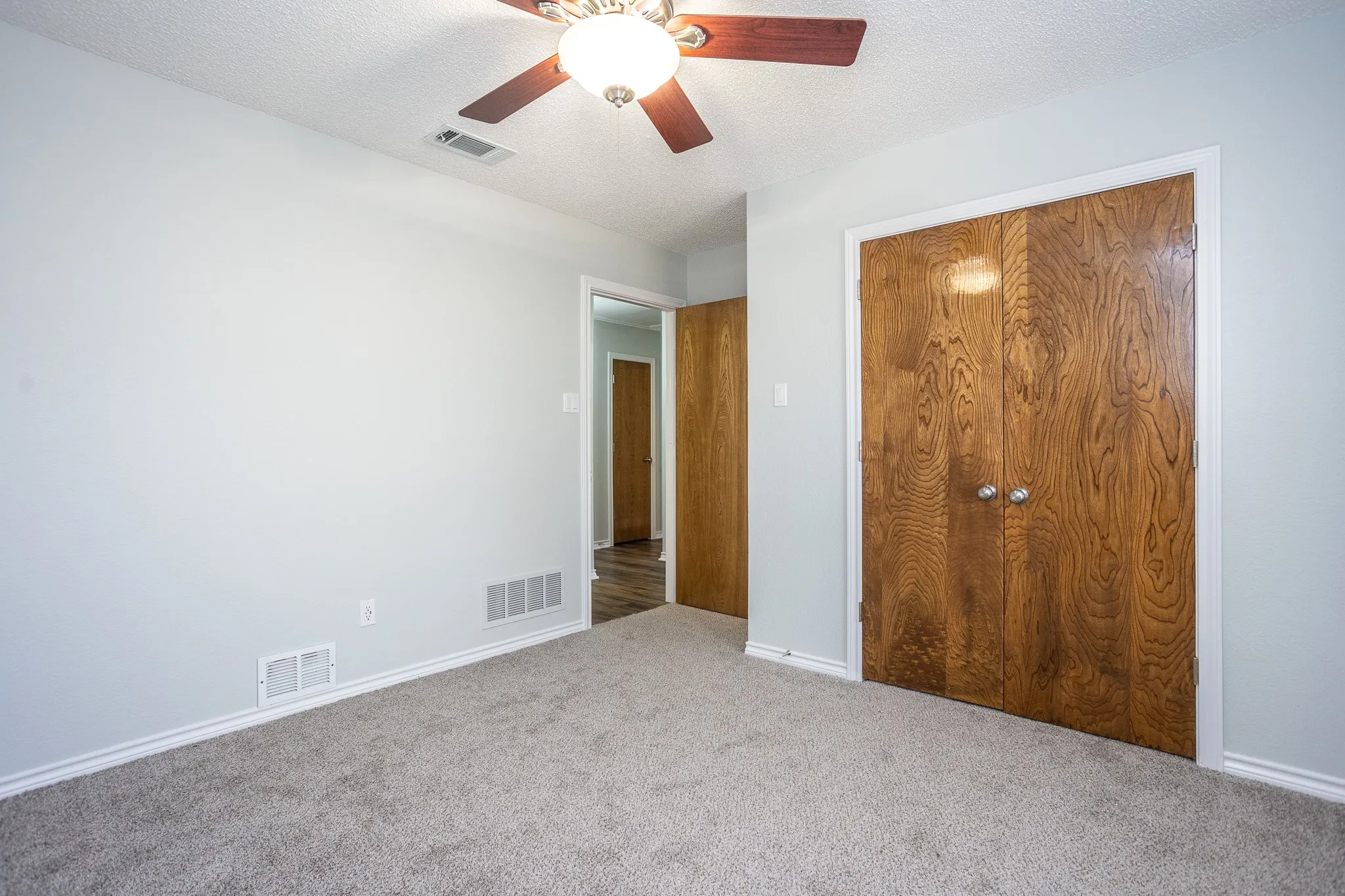 SOFT GRAY CARPET AND CEILING FAN
