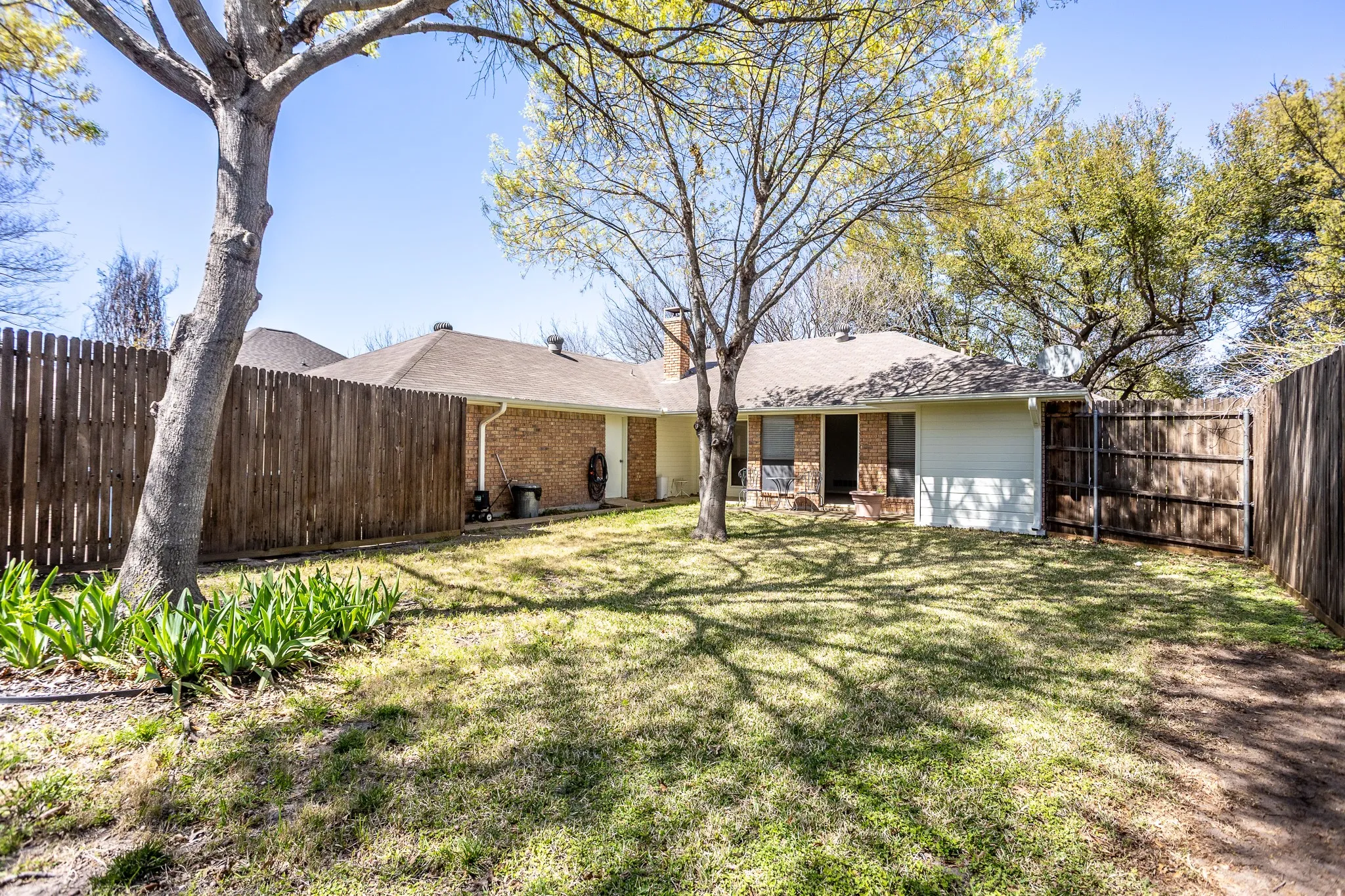 NICE YARD WITH TALL PRIVACY FENCE PERFECT FOR A RELAXING EVENING