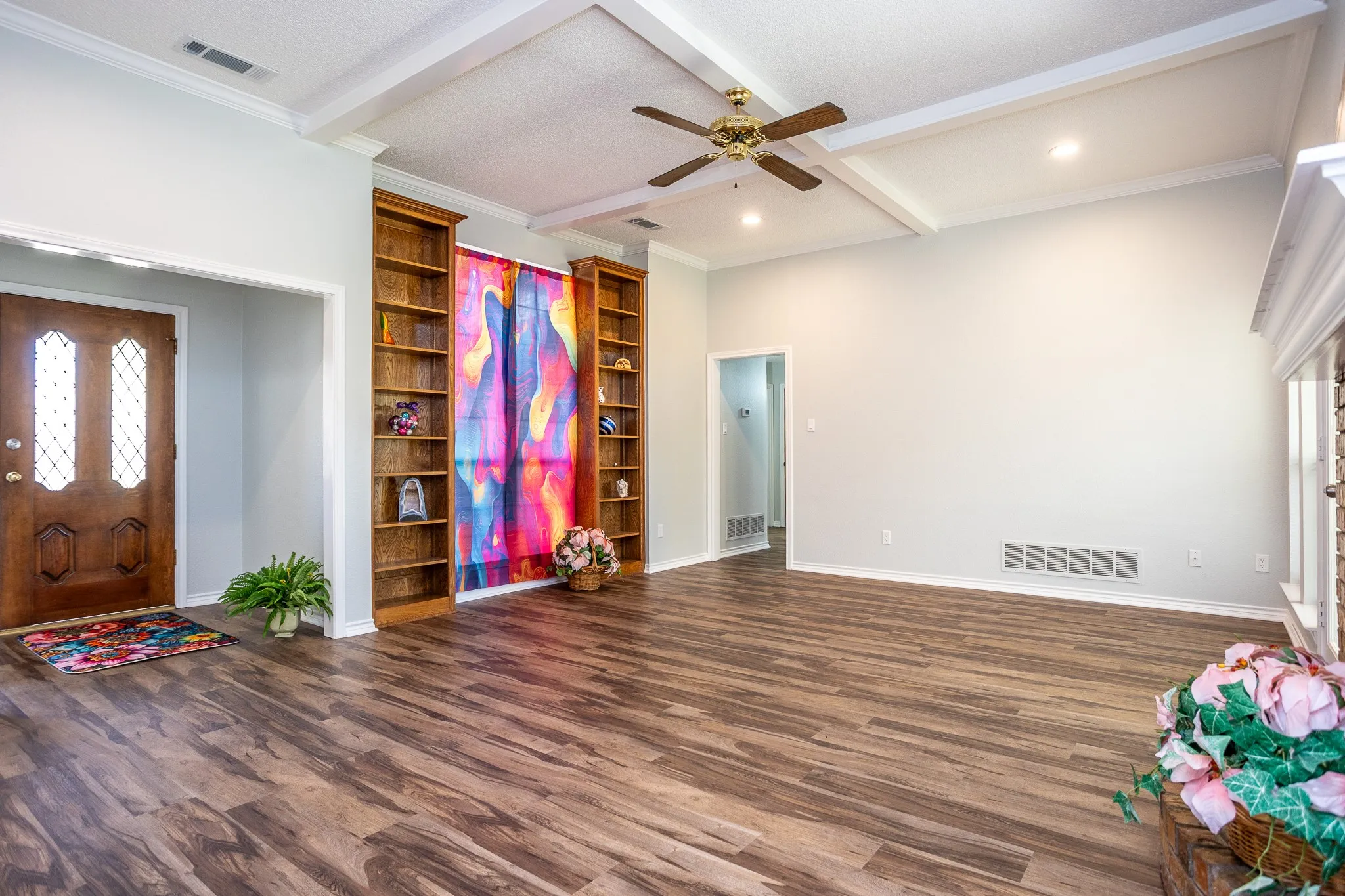 BUILT-INS SHELVING IN LIVING AREA WITH FULL WINDOW FOR LOTS OF LIGHT