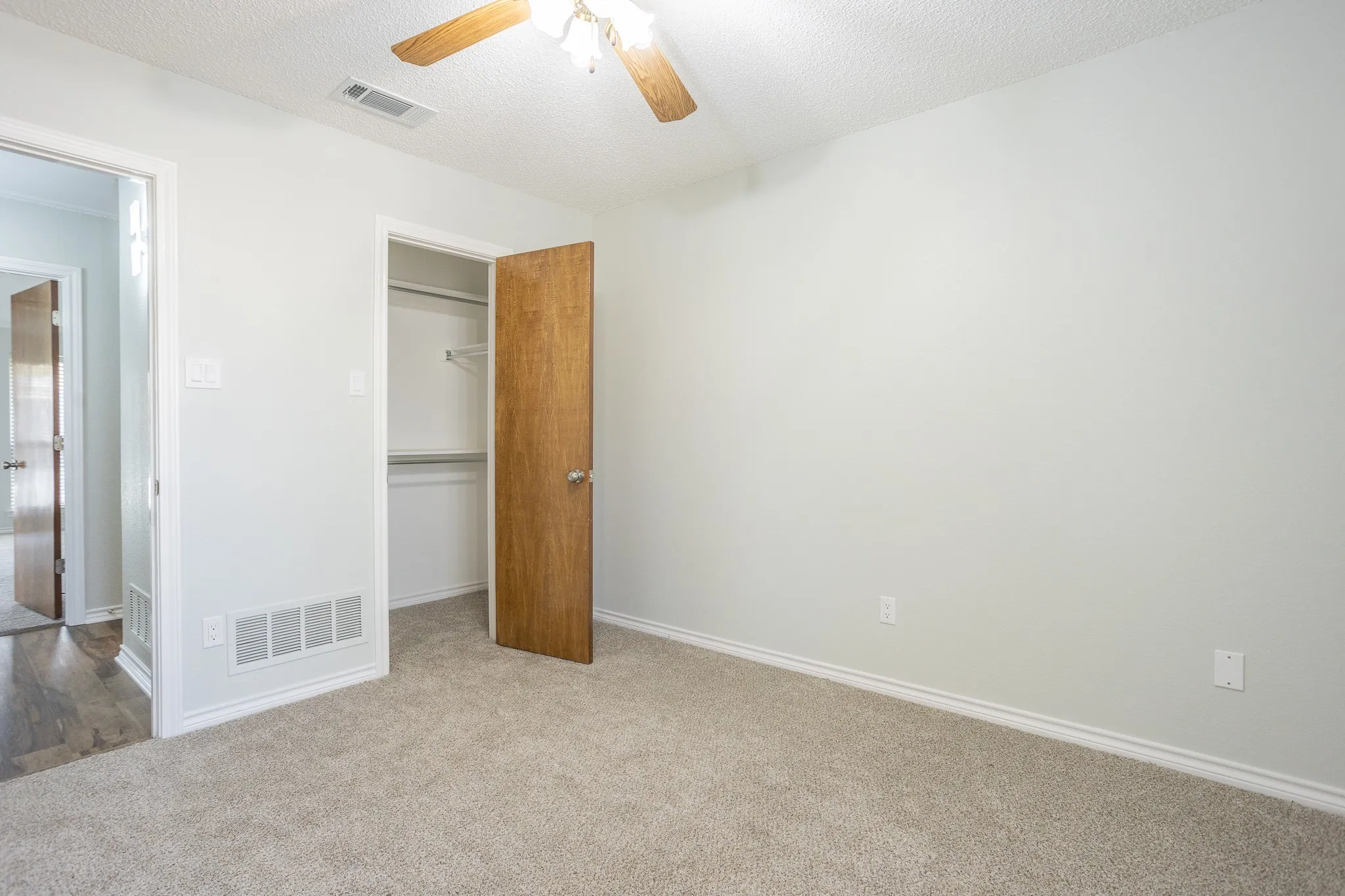 MIDDLE BEDROOM SHOWING CLOSET AND CEILING FAN